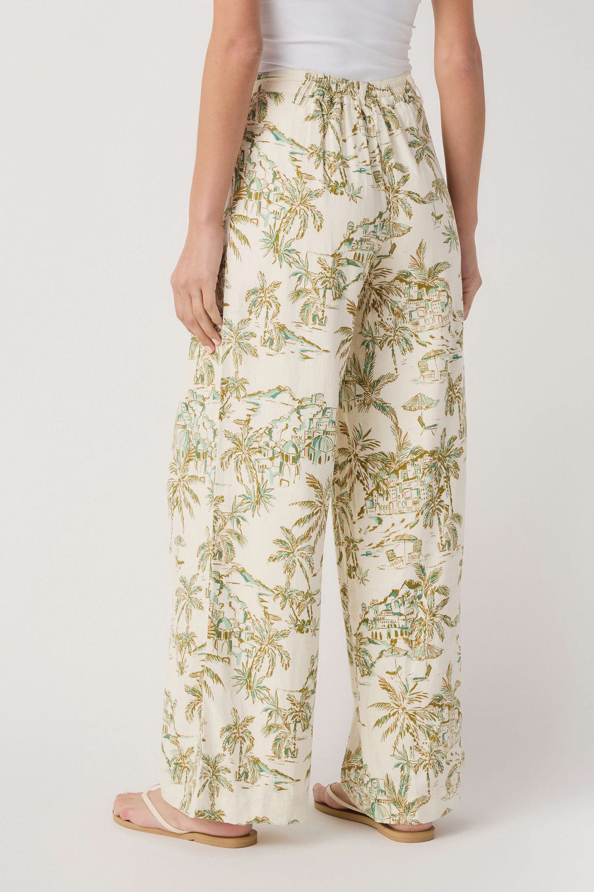 Cream tropical palm-print linen pants with elastic waistband and flowy wide legs