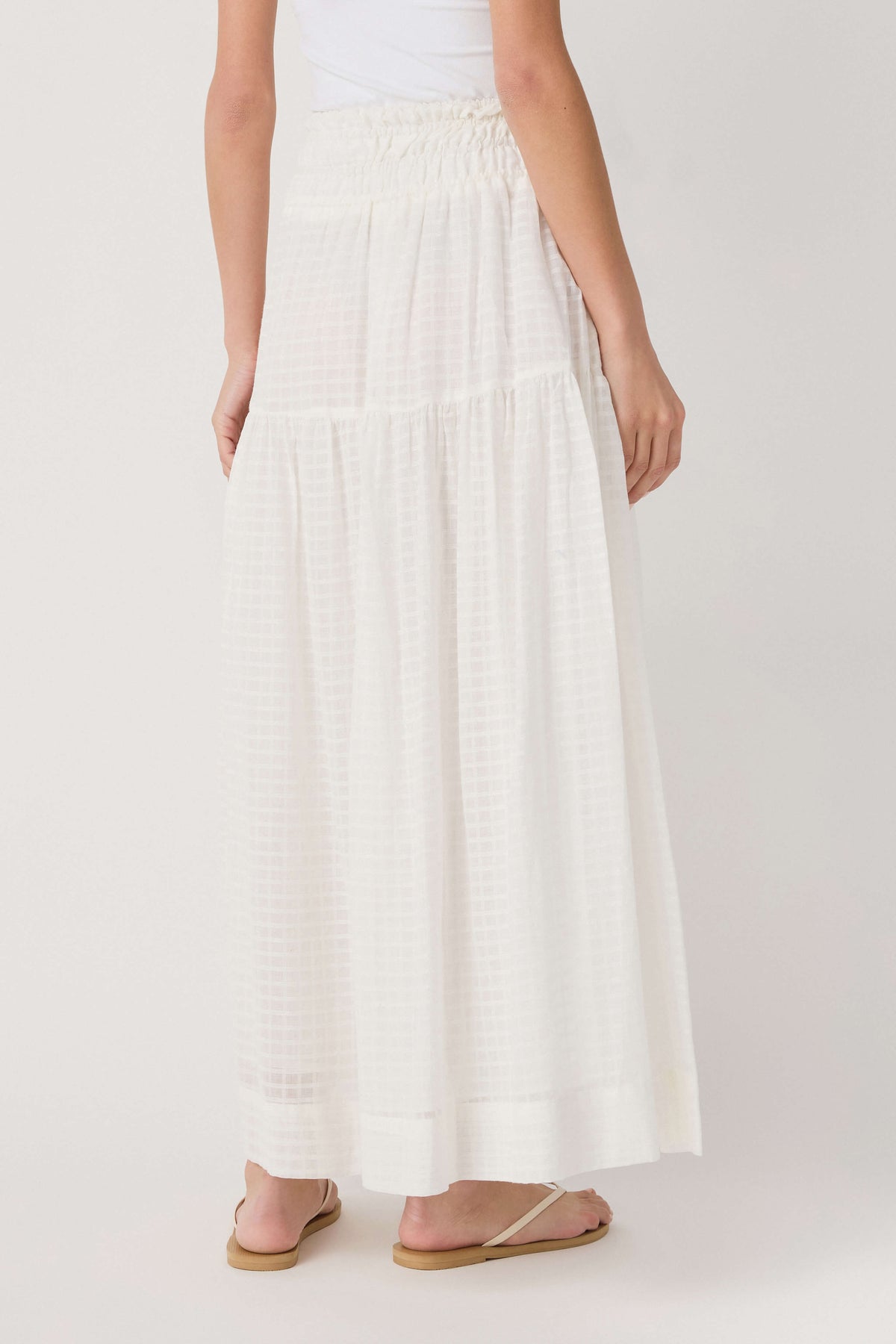 Off-white tiered maxi skirt with elastic smocked waistband, full length