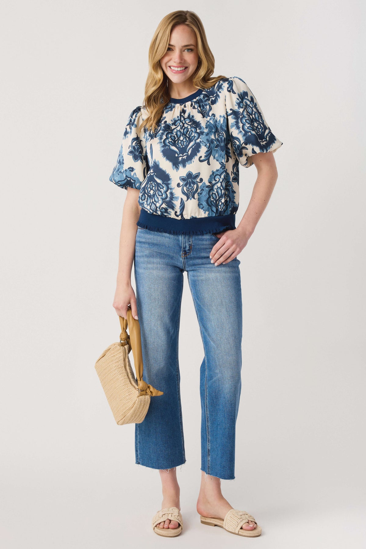 Tan woven top-handle bag with rounded woven body