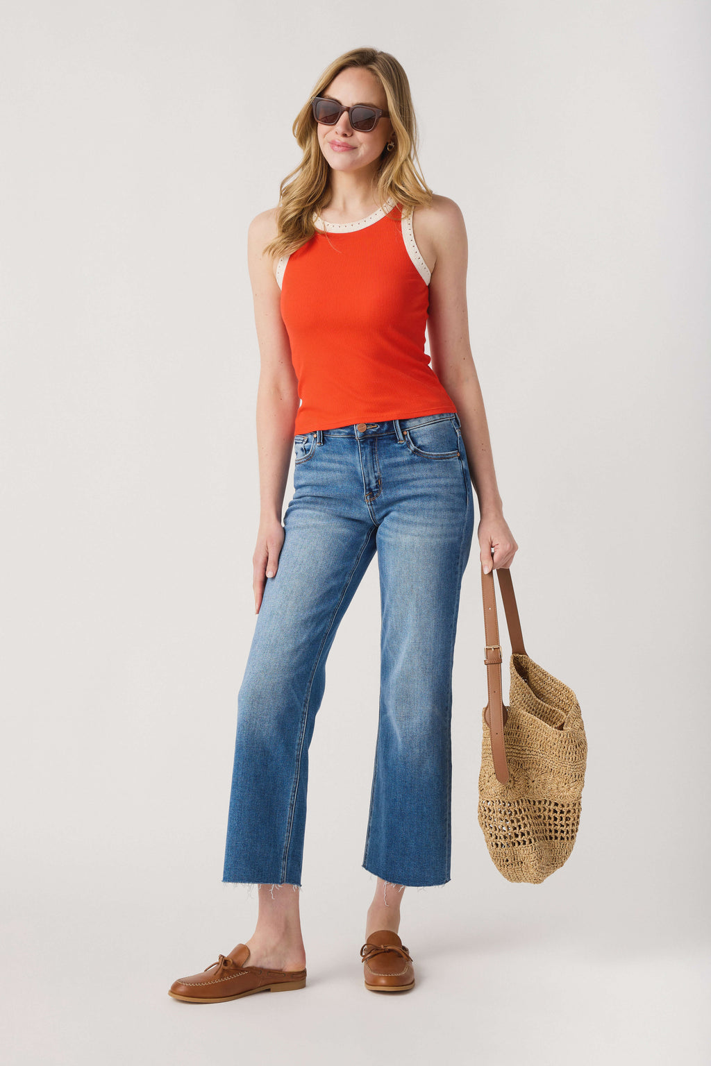 Orange ribbed tank top with white contrast neckline and armhole trim, sleeveless.