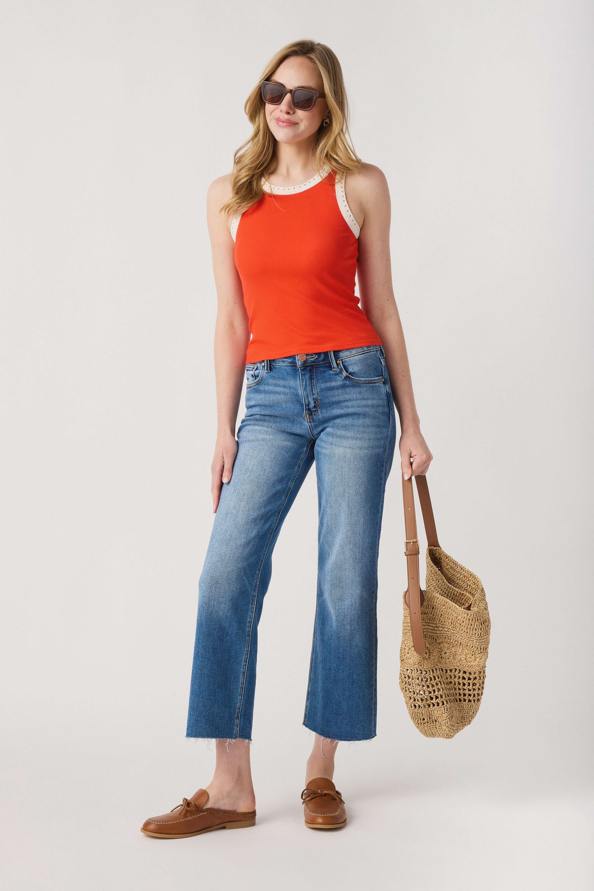 Orange ribbed tank top with white contrast neckline and armhole trim, sleeveless.