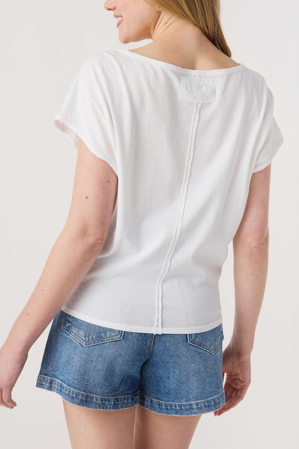 White back short-sleeve tee with center seam and small opening at yoke