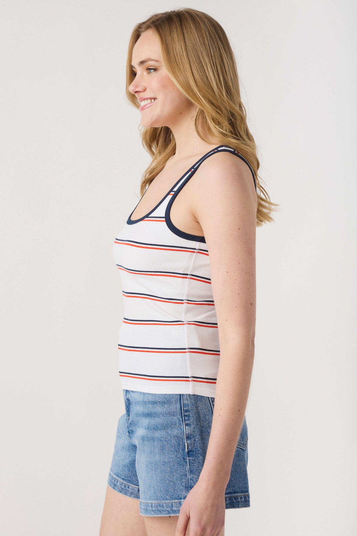 White rib tank with navy trim and red/gray stripes, sleeveless scoop neckline.