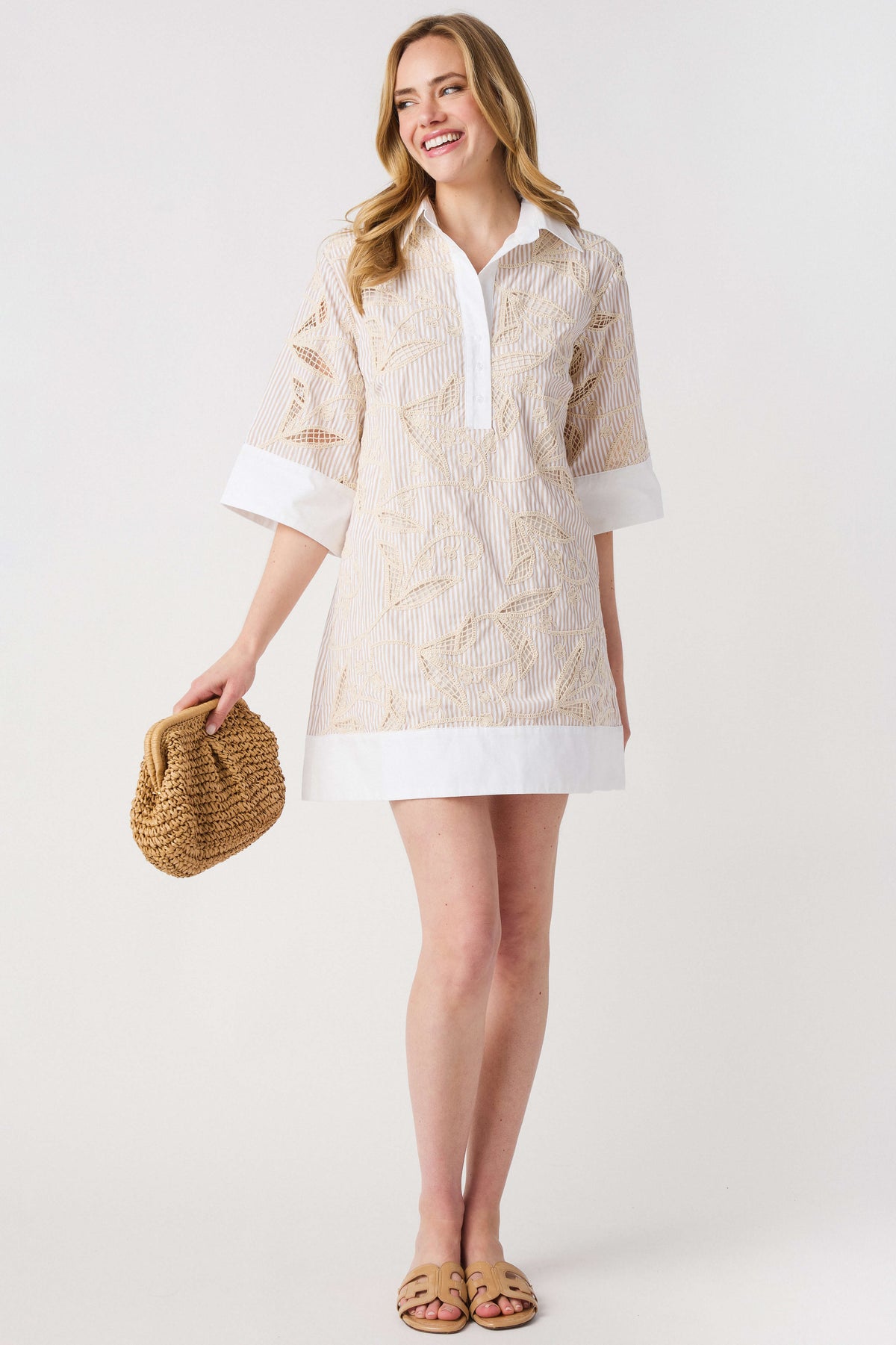 Floral embroidered shirt dress with white contrast collar and hem; light taupe base, side view.