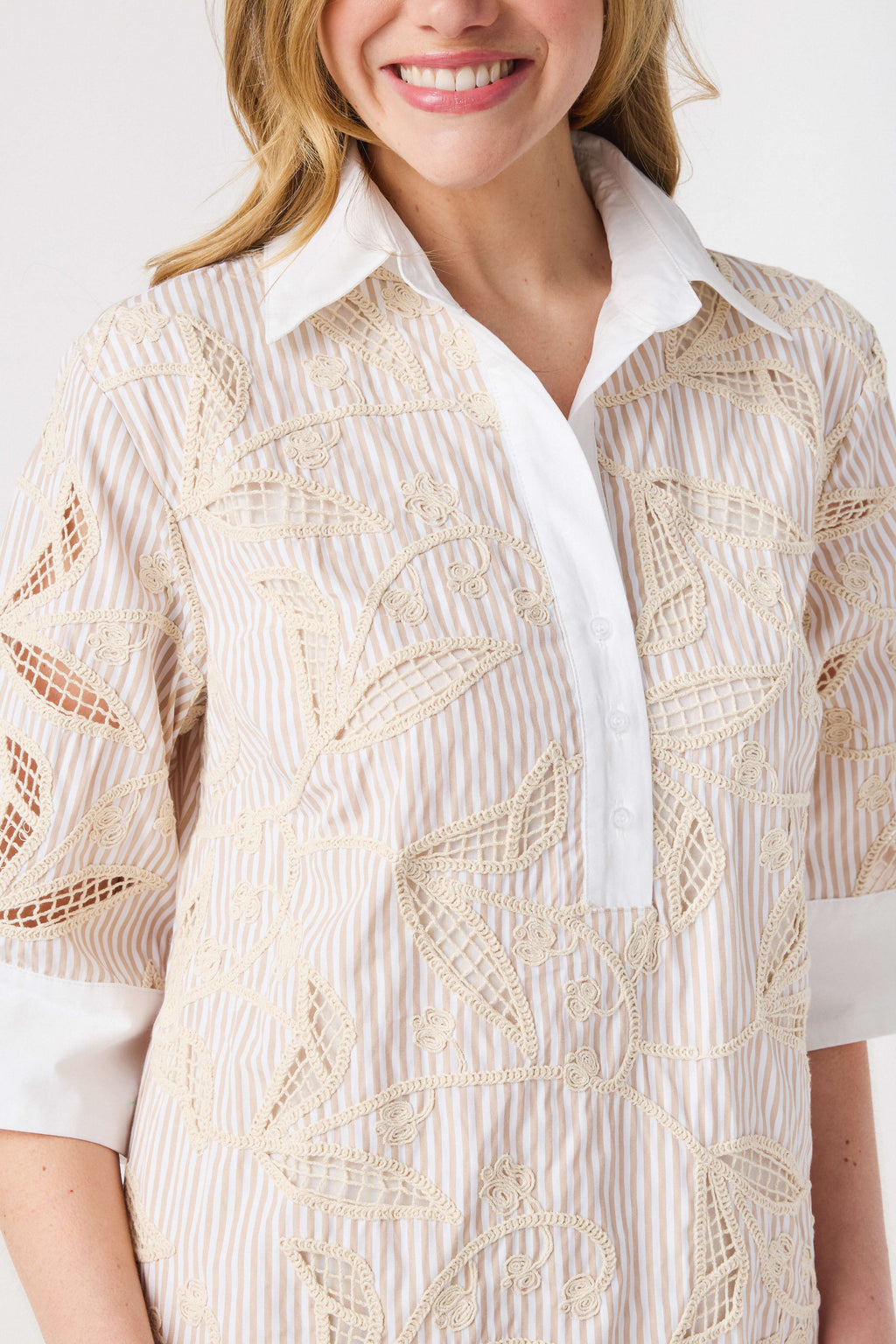 Floral embroidery shirt dress close-up with white collar and placket; light taupe pattern.