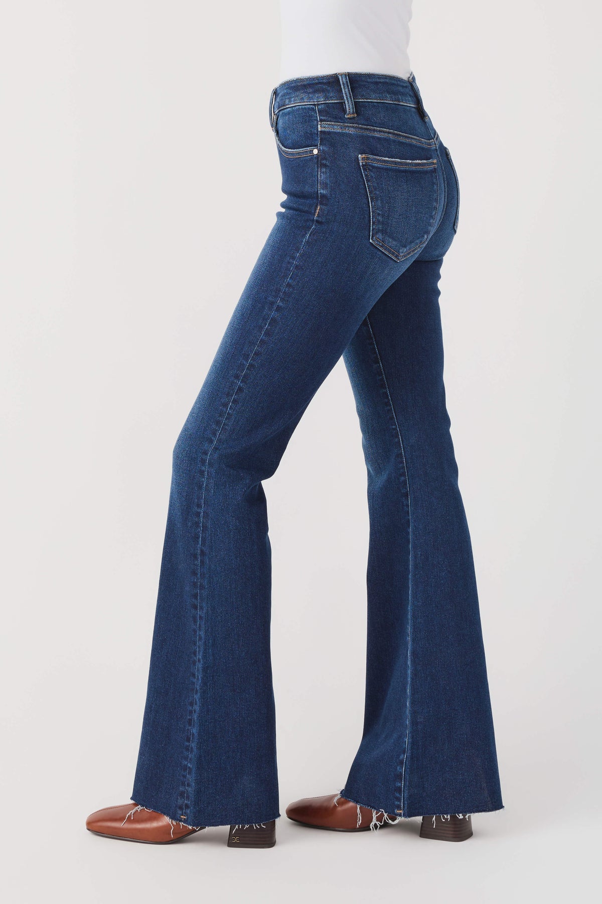 High-rise flare jeans, dark blue denim, side view with long bell-leg hem