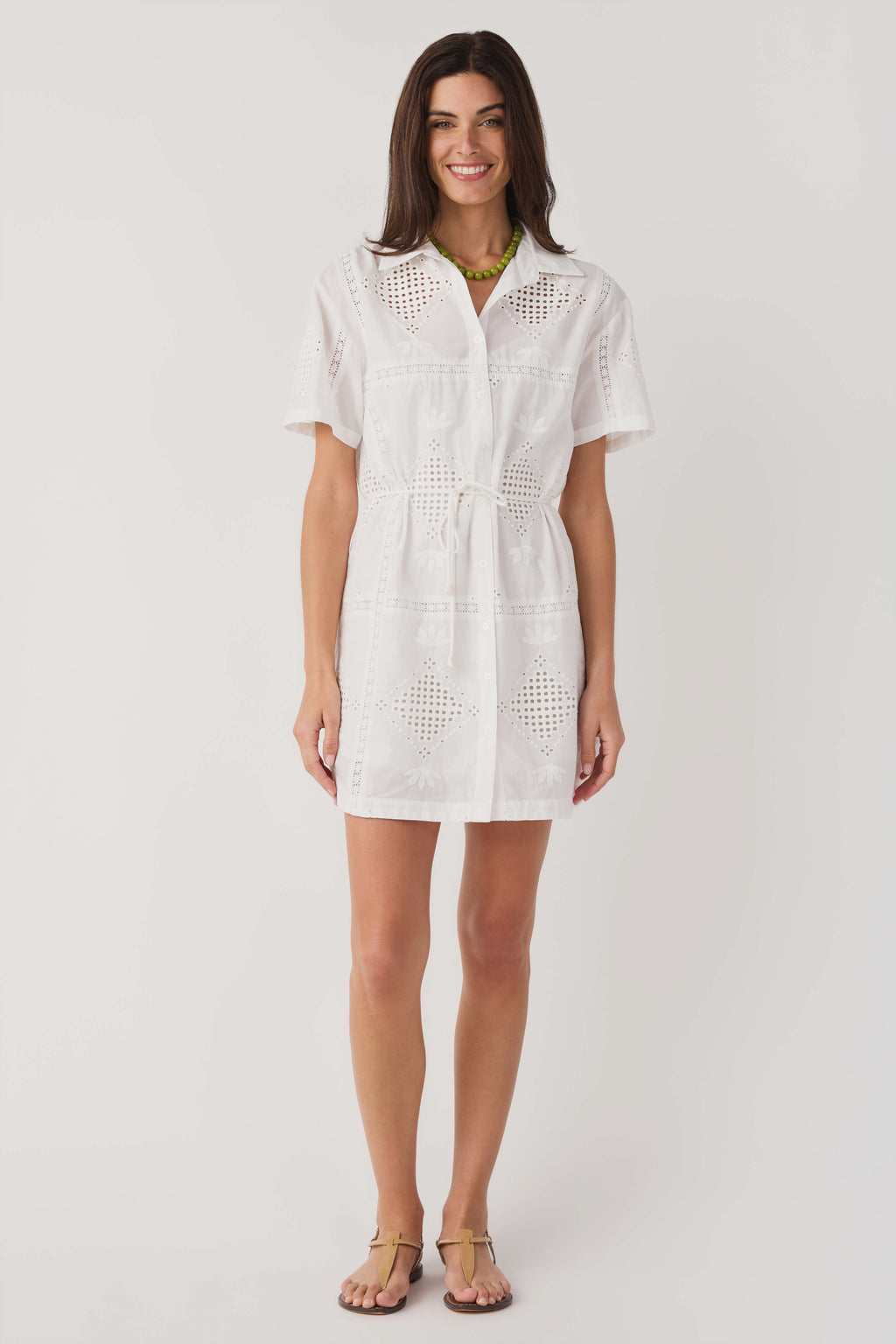 White eyelet mini dress with short sleeves and V-neck, front button placket