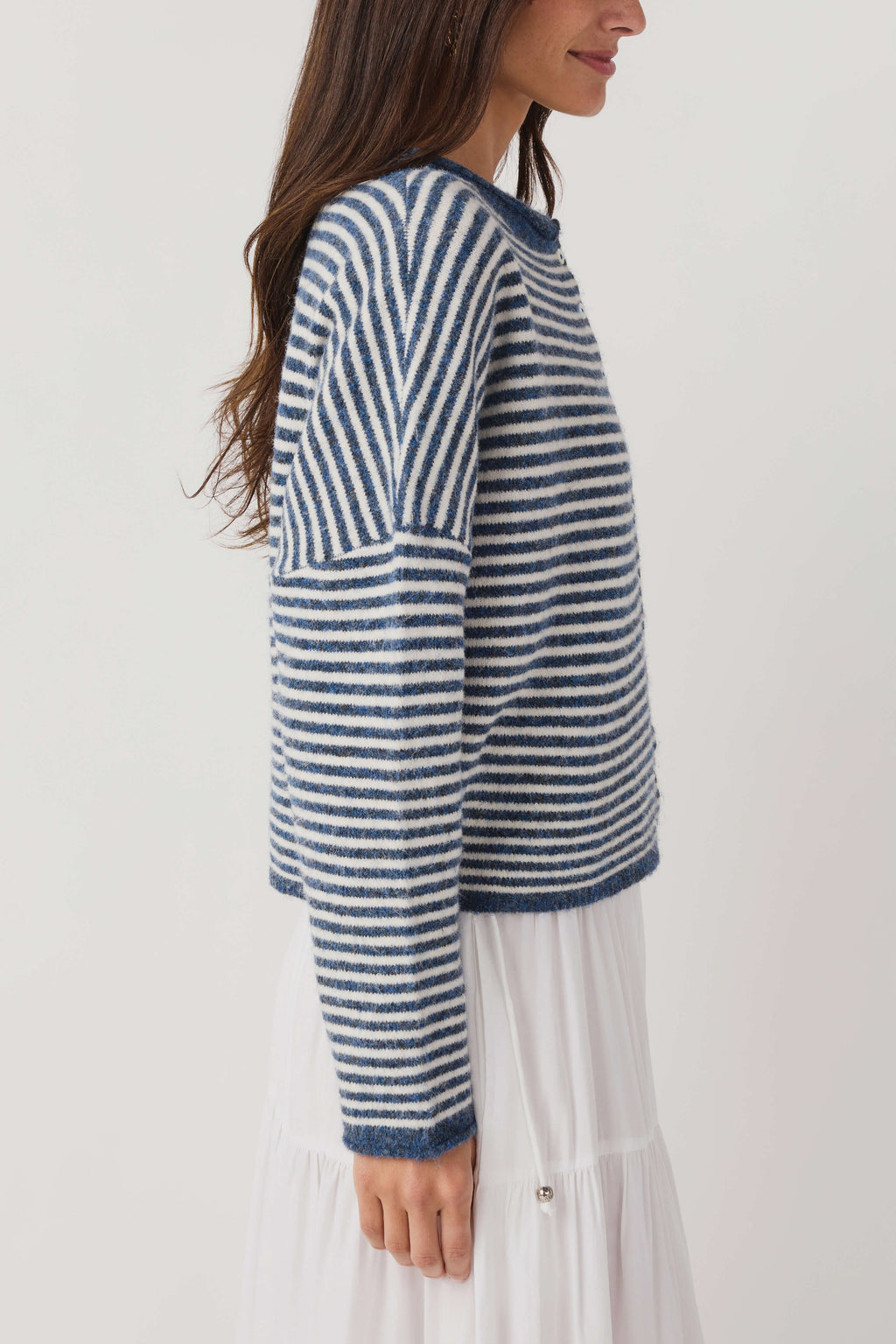 Striped knit cardigan side view; blue-and-white striped knit with long sleeves