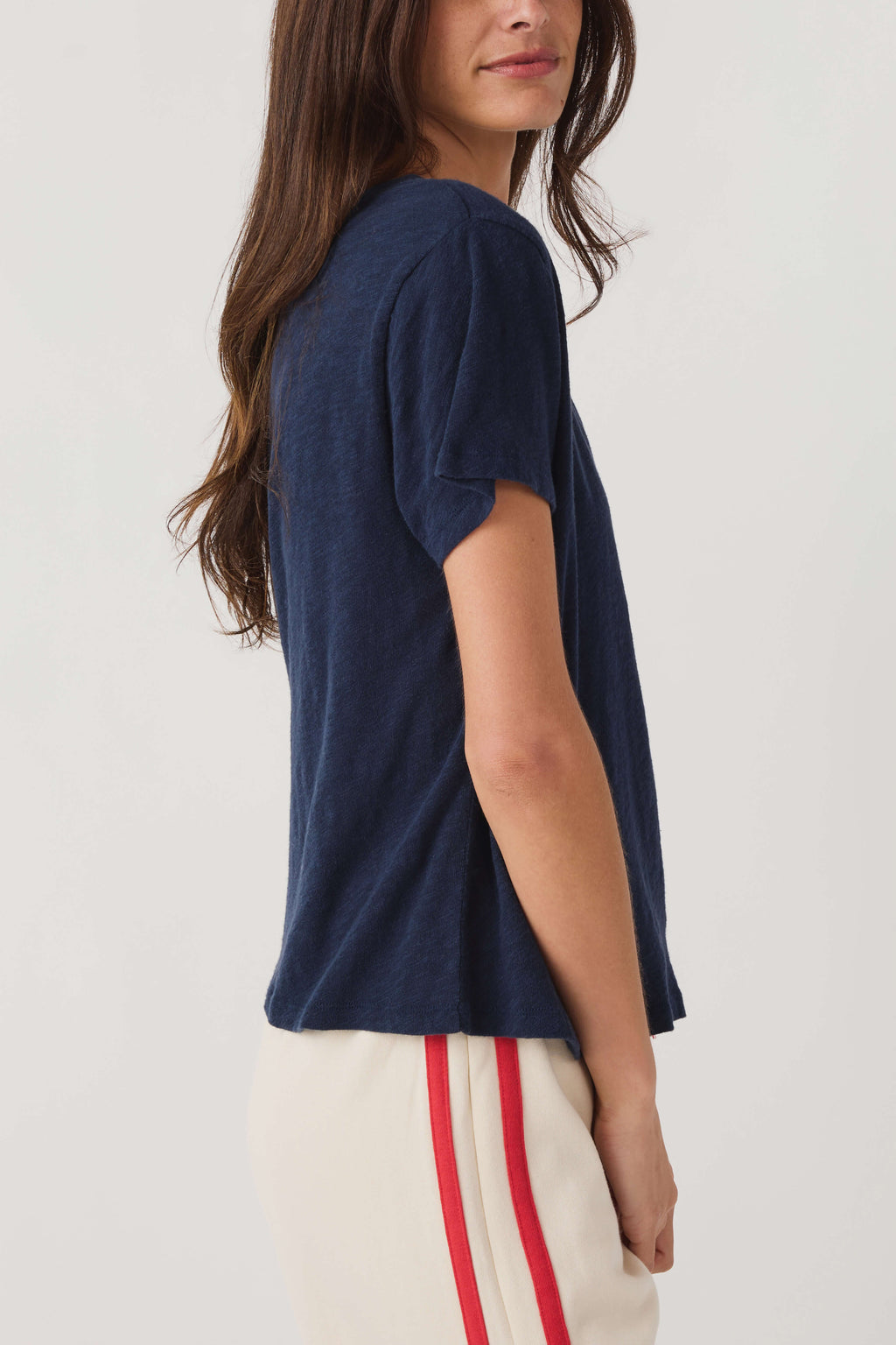 Navy V-neck short-sleeve tee in side view, slightly loose silhouette