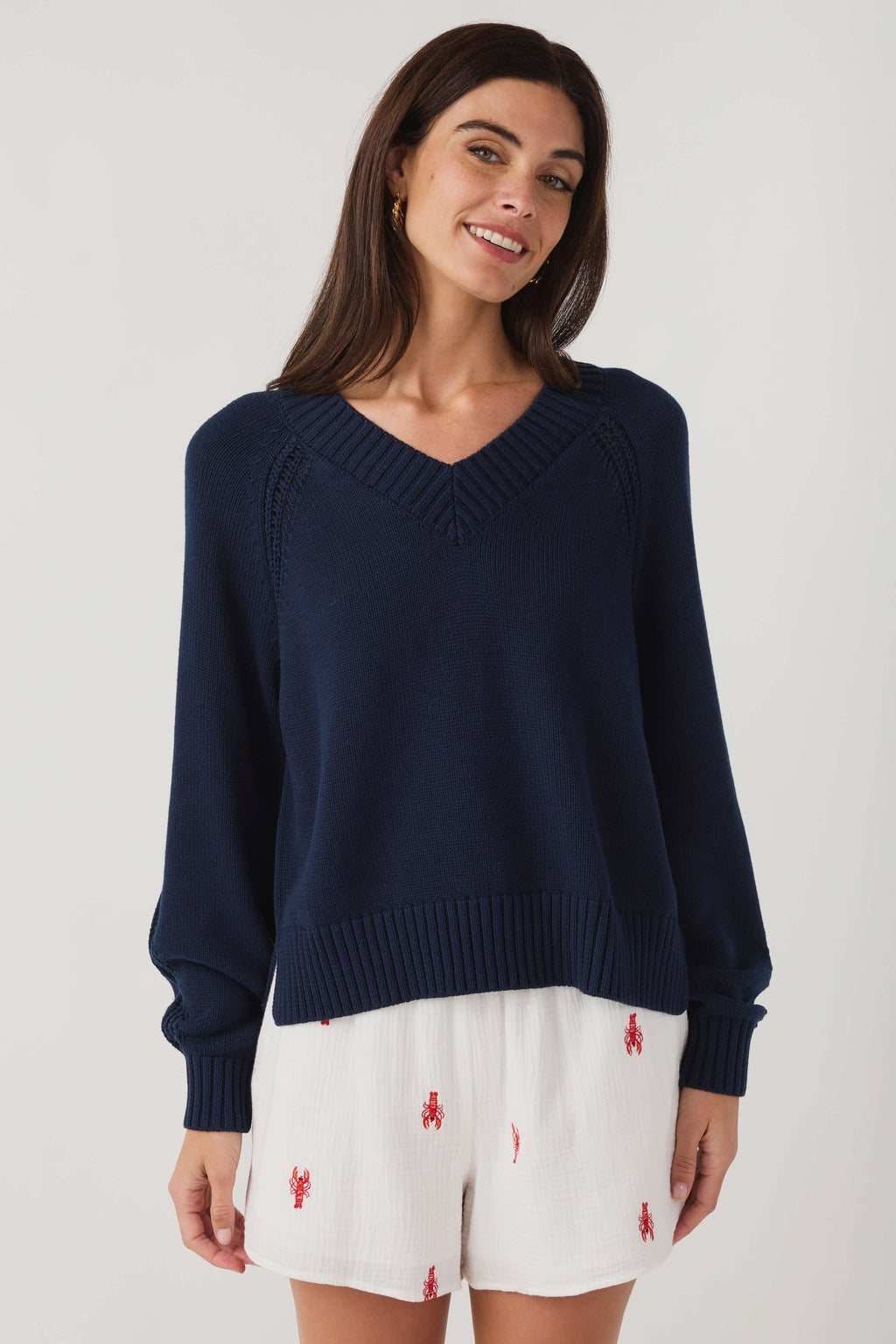 Women's navy V-neck knit sweater with ribbed V yoke and long sleeves