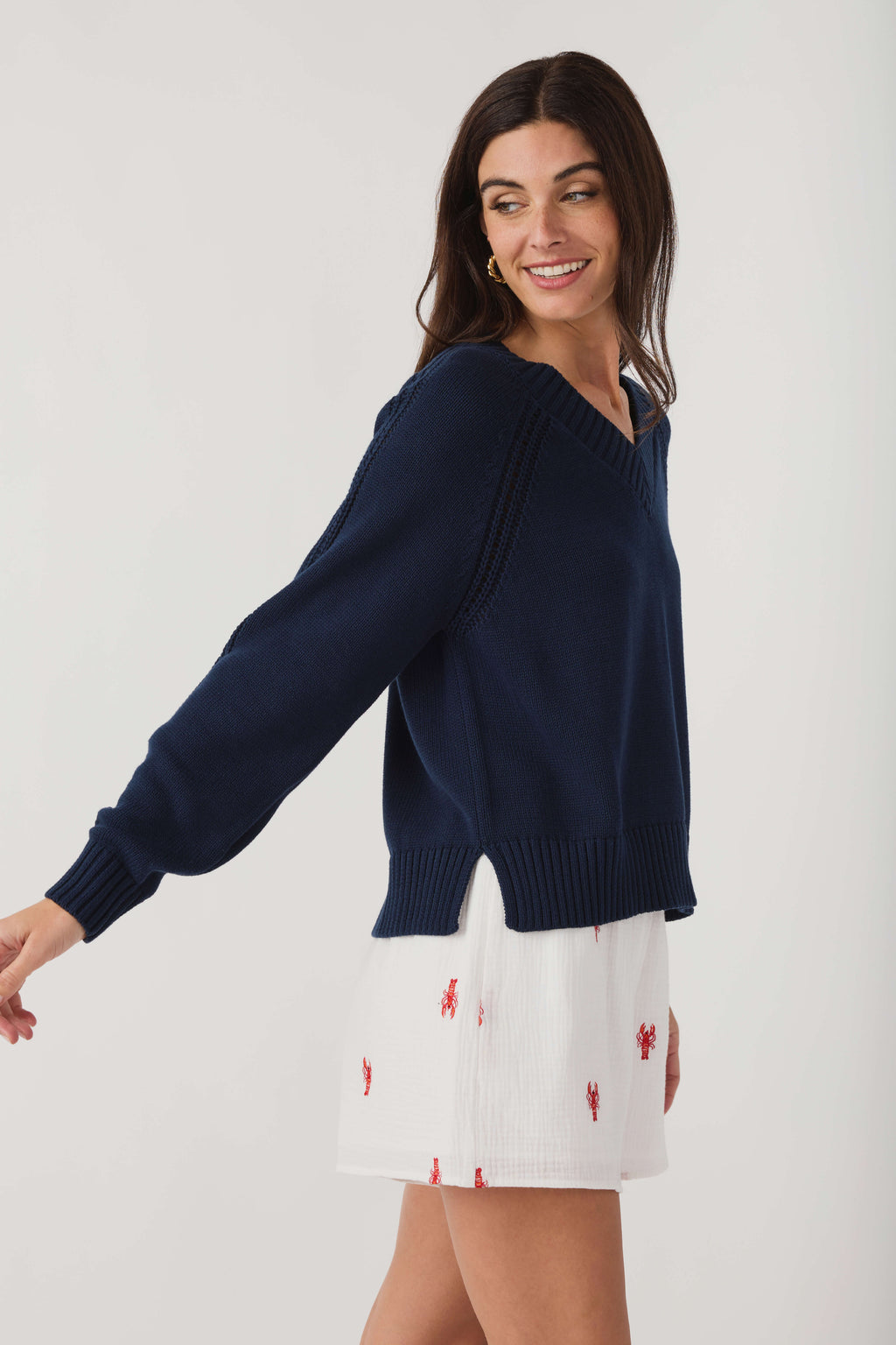Women's navy V-neck knit sweater with ribbed cuffs and relaxed fit