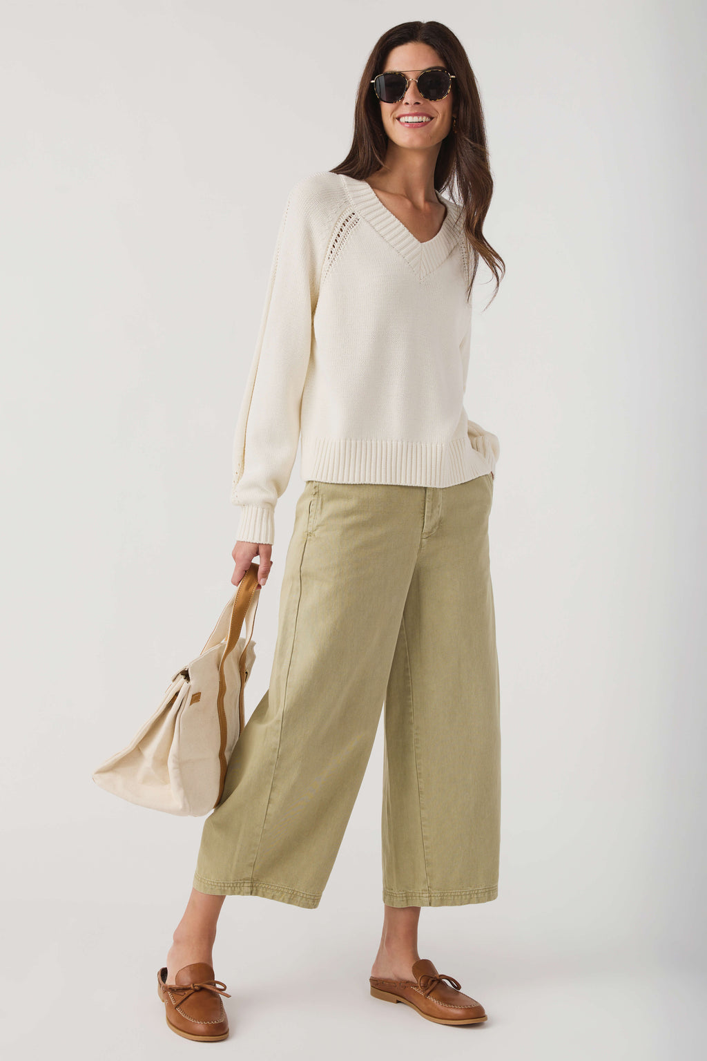 Ivory chino pants with belt loops, front pockets, and a cropped wide-leg silhouette
