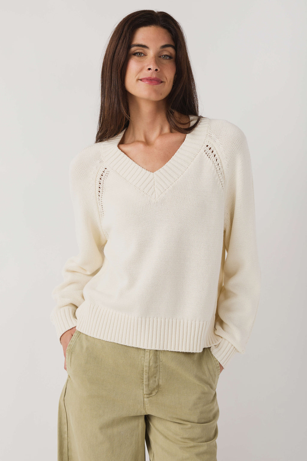 Women's light sand V-neck knit sweater with dotted shoulder trim and ribbed waist hem