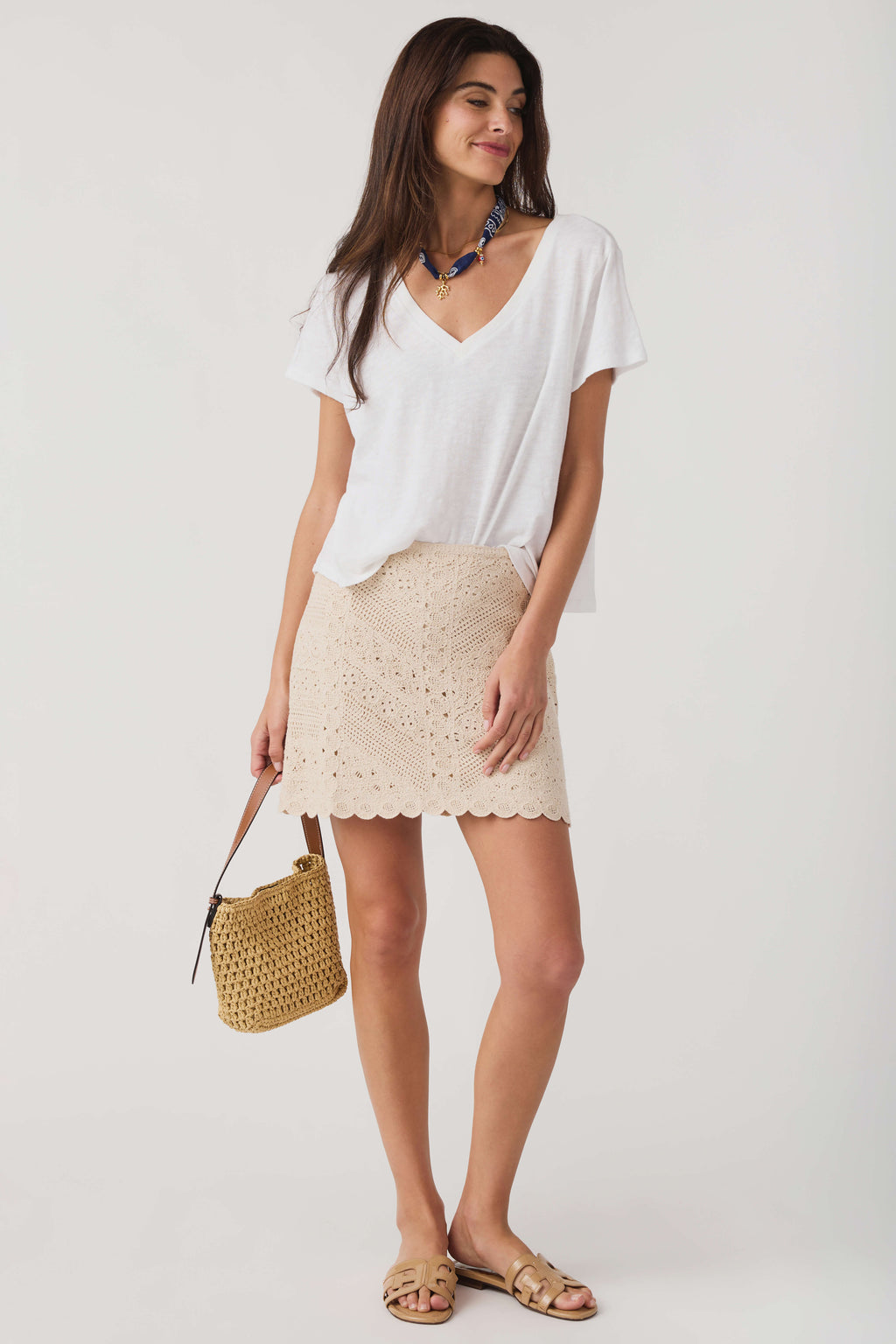 Natural eyelet mini skirt with scalloped hem and embroidered dot pattern