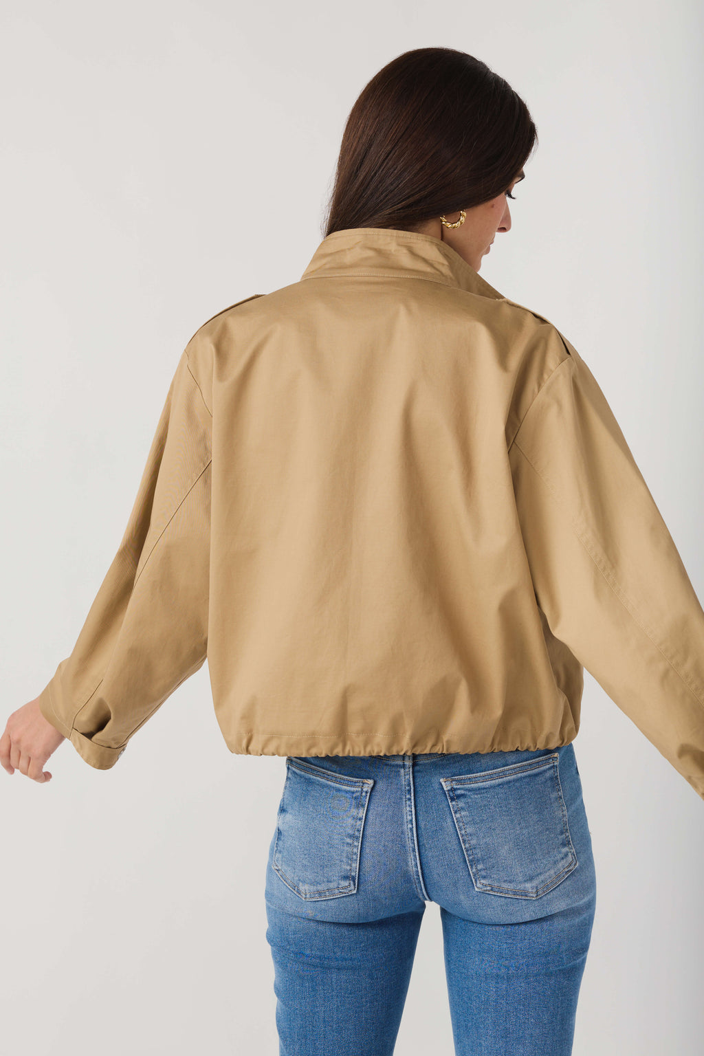 Back view of khaki beige utility short jacket with yoke seam and drawstring hem