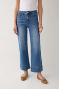 Medium-wash wide-leg ankle jeans front view with button closure and stitched cuff hem