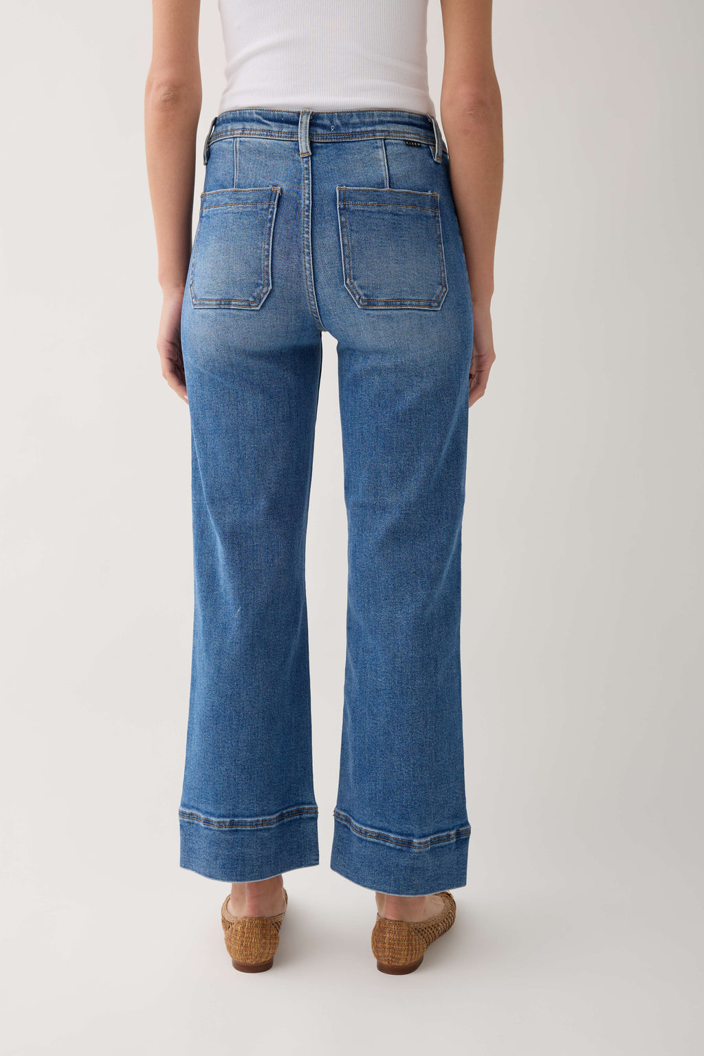 Medium-wash wide-hem ankle jeans with back patch pockets and relaxed, straight leg