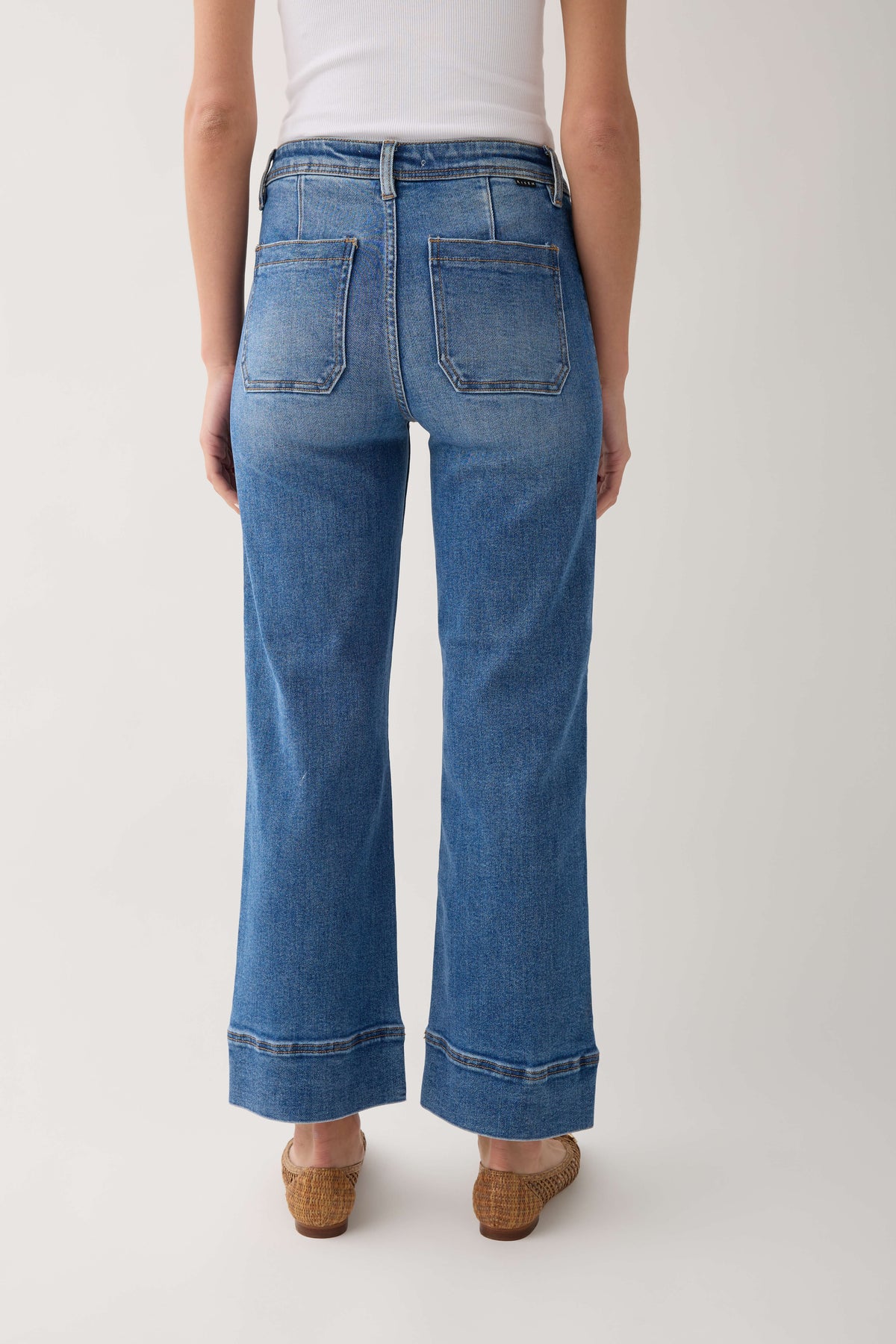 Medium-wash wide-hem ankle jeans with back patch pockets and relaxed, straight leg
