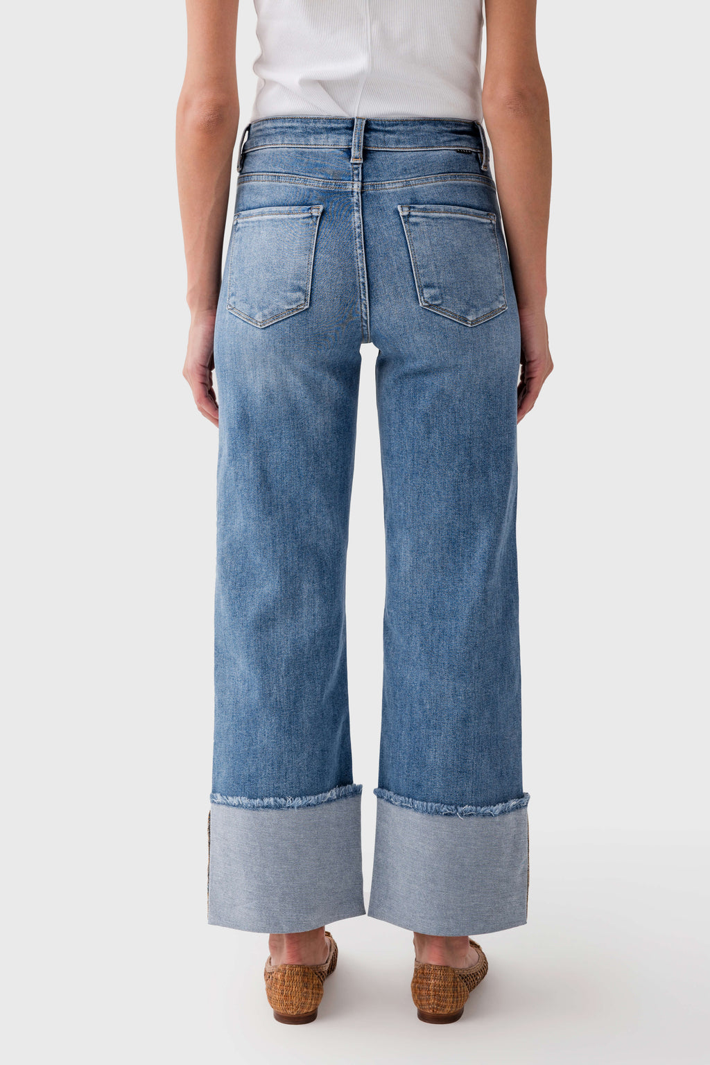 Medium-wash cuffed jeans with two back pockets and wide, cuffed hems