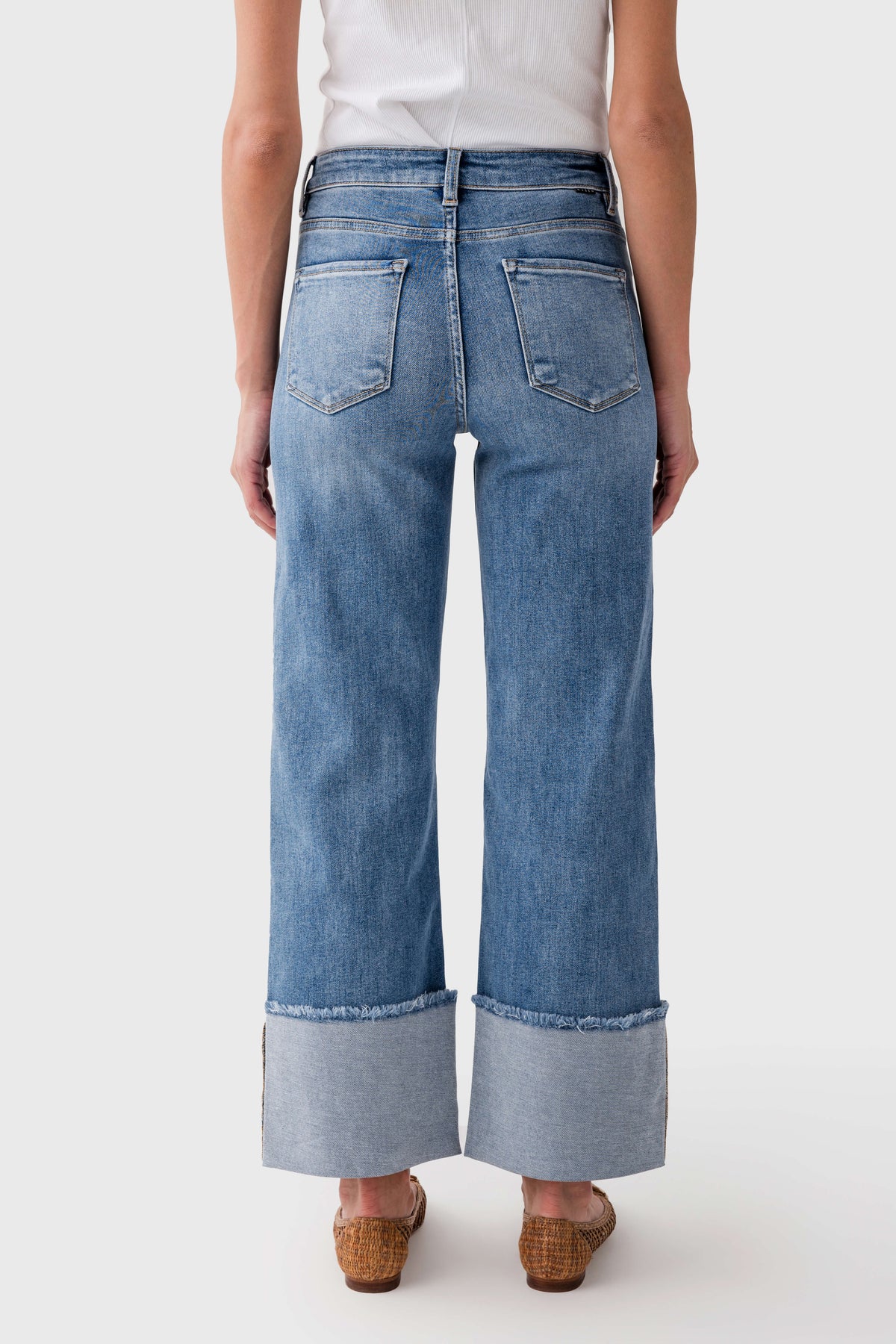 Medium-wash cuffed jeans with two back pockets and wide, cuffed hems