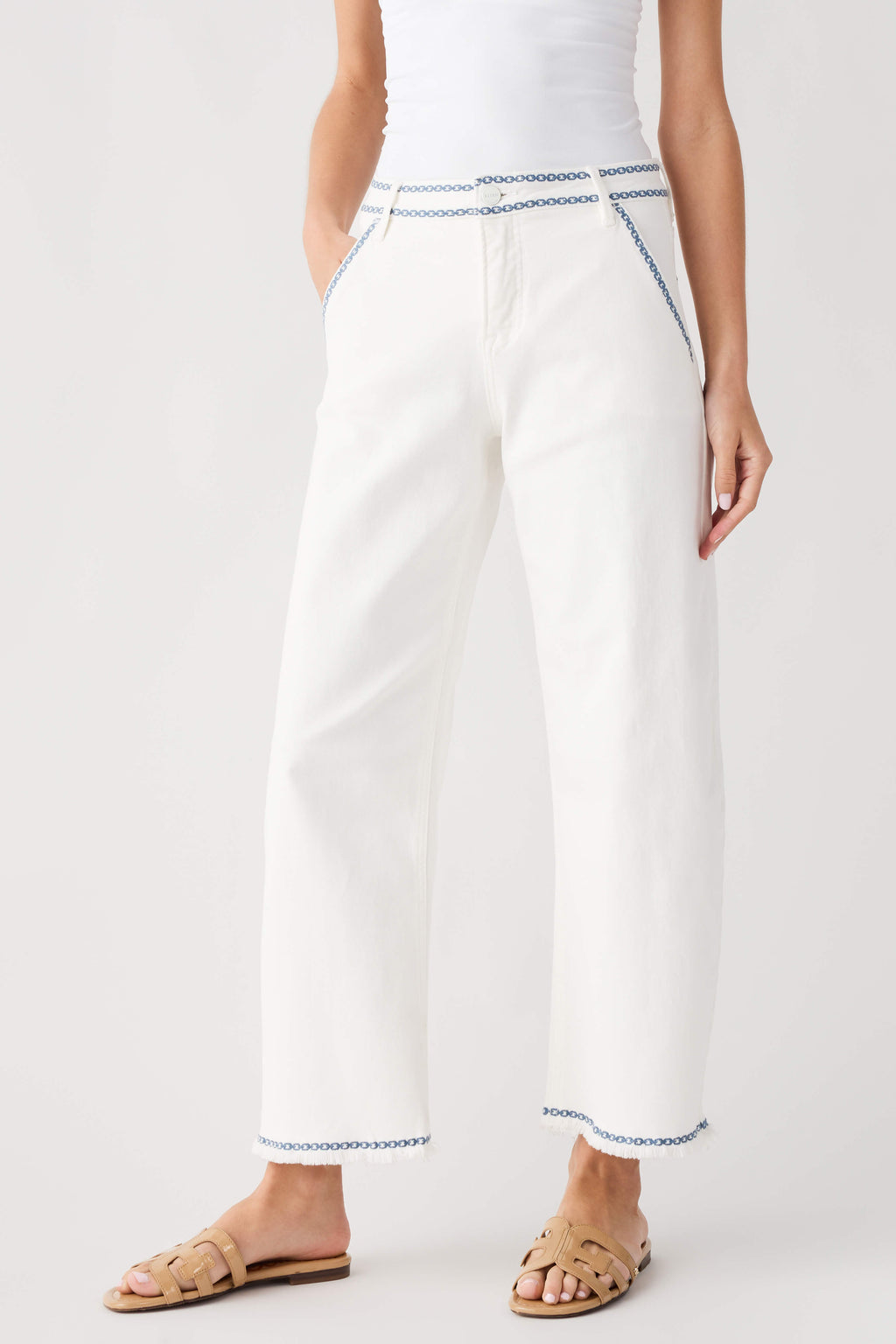 Cream embroidered cropped barrel jeans with blue trim at cuffs and hems