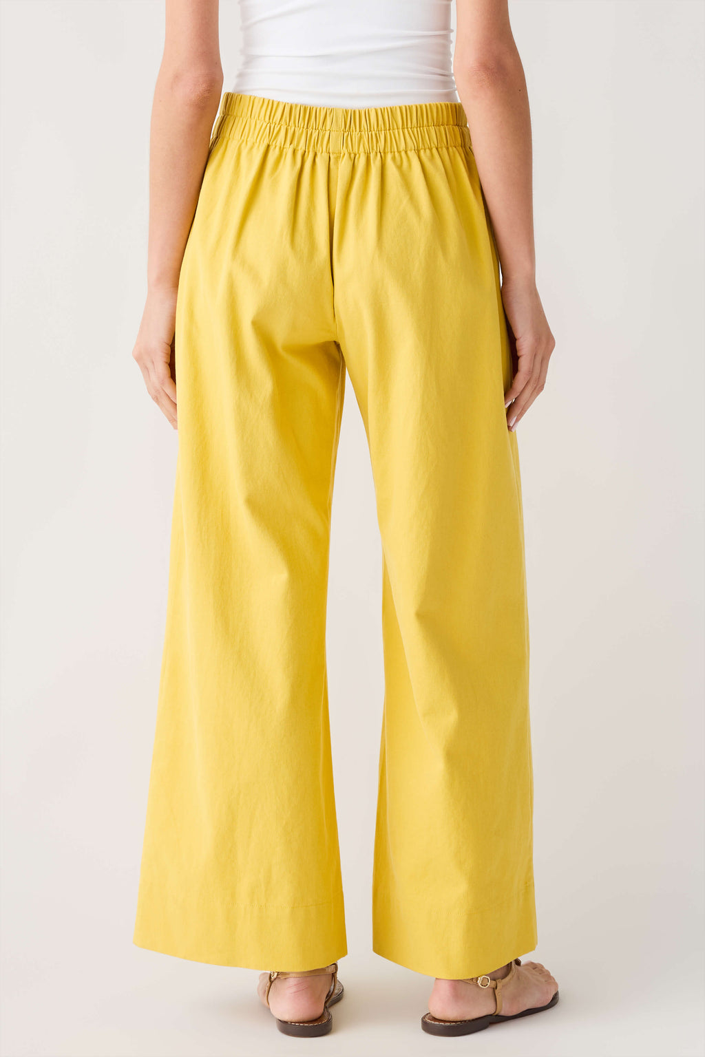 Mustard yellow elastic-waist wide-leg trousers with a relaxed drape