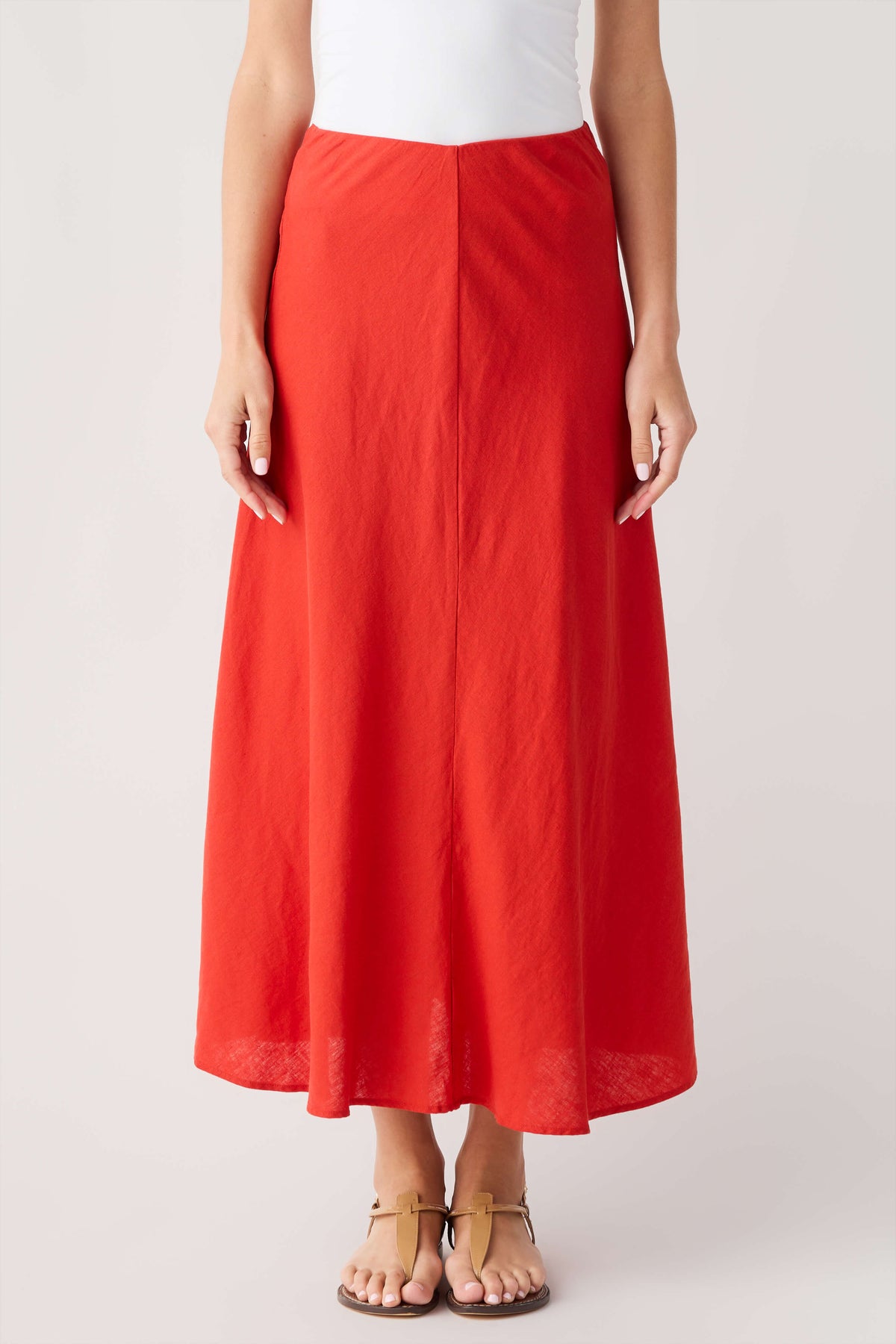 Red midi A-line skirt with smooth front and softly flared hem