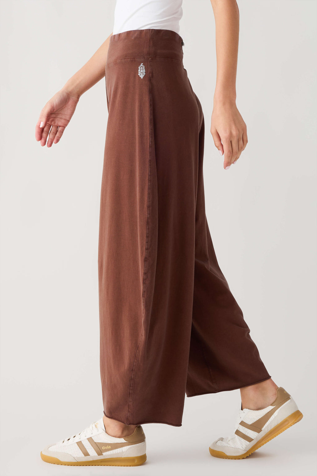 Women’s brown wide-leg easy pants in a side view with roomy straight-leg fit