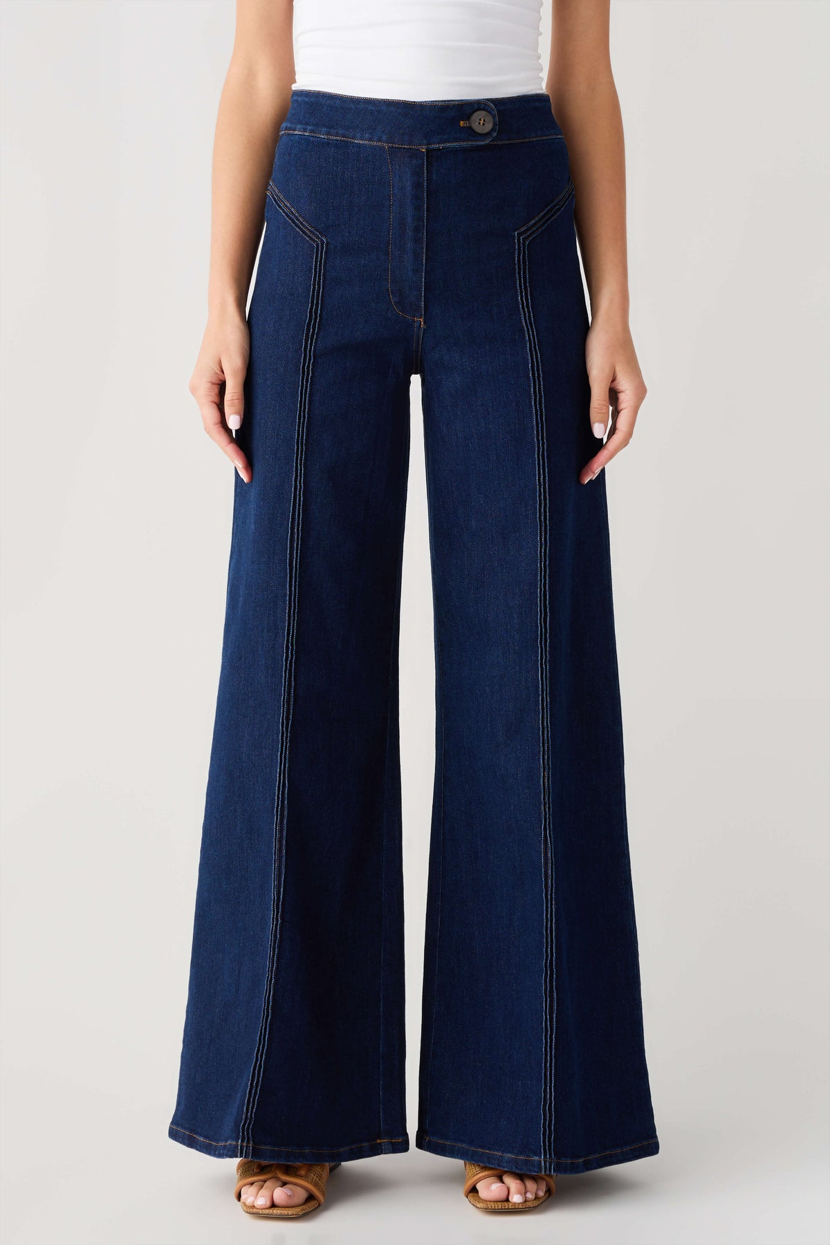 High-waisted dark denim flare pants with button waistband and front patch pockets