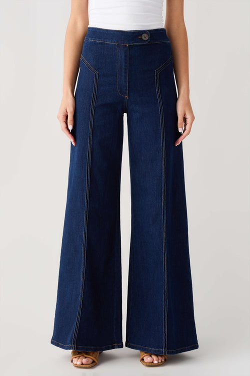 High-waisted dark denim flare pants with button waistband and front patch pockets