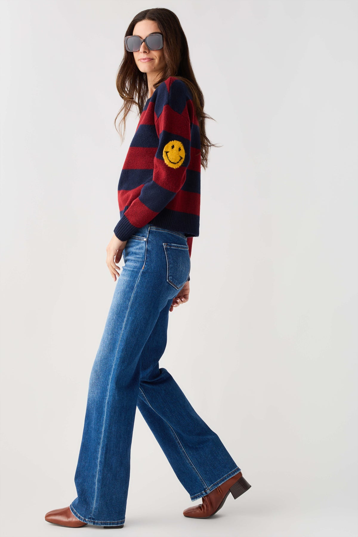 Striped smiley face sweater in navy and burgundy, smiley graphic on chest