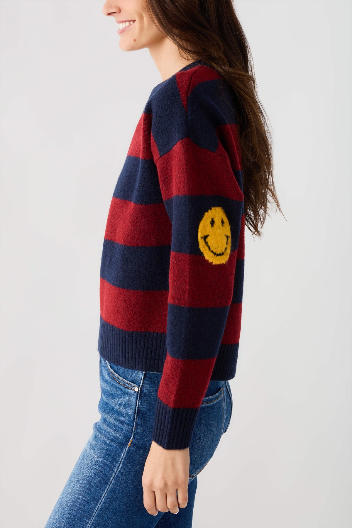 Striped smiley face sweater in navy and burgundy, smiley graphic on sleeve