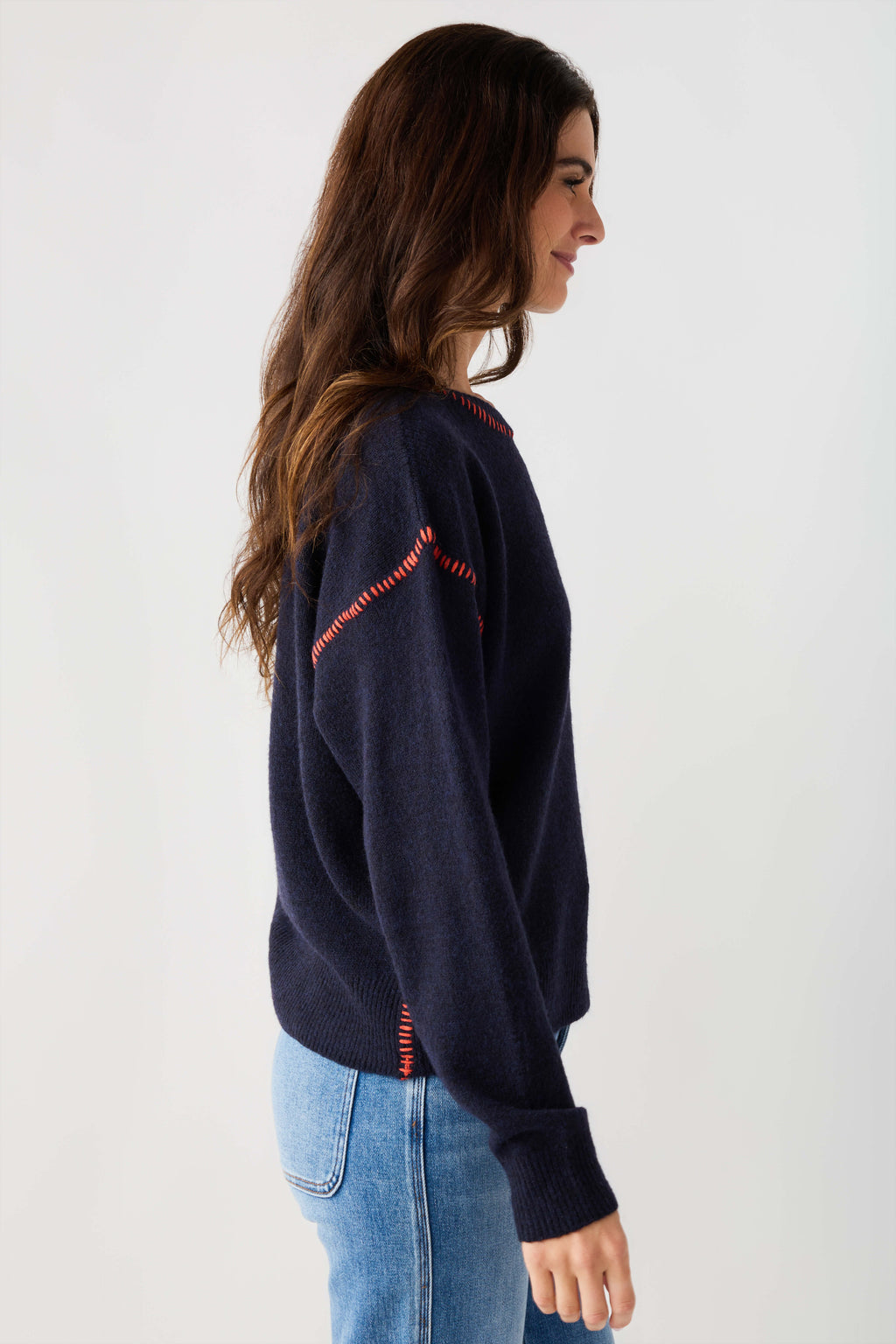Navy crewneck sweater with contrast stitch detailing on sleeves
