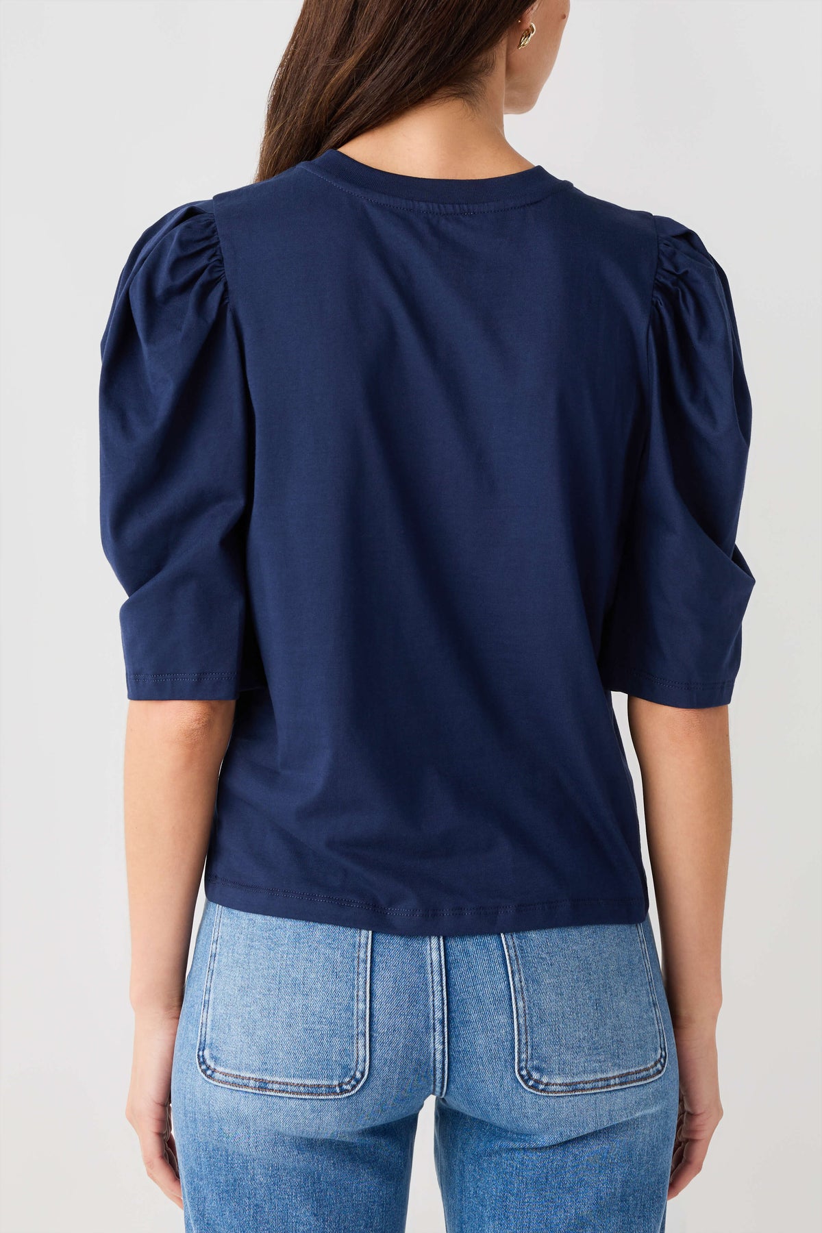 Navy puff-sleeve jersey top with gathered shoulders and smooth back yoke