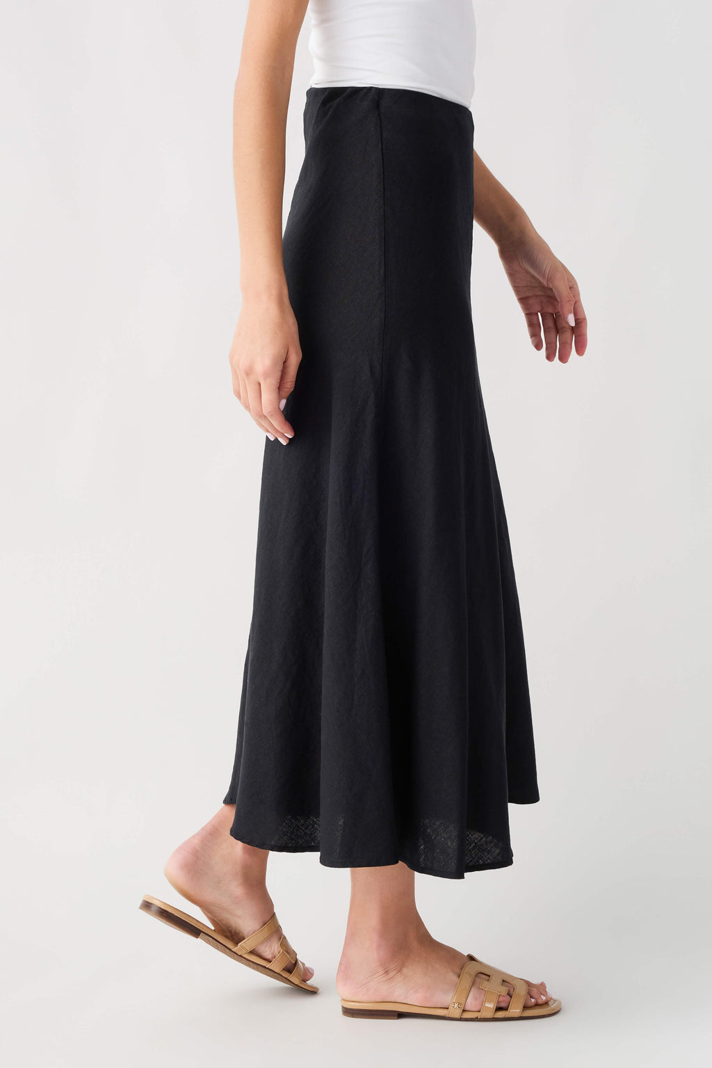Black midi A-line skirt, back/side view with gently flared hem