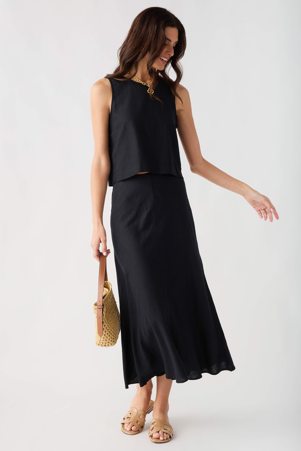 Black midi skirt with asymmetrical drape and softly flared hem