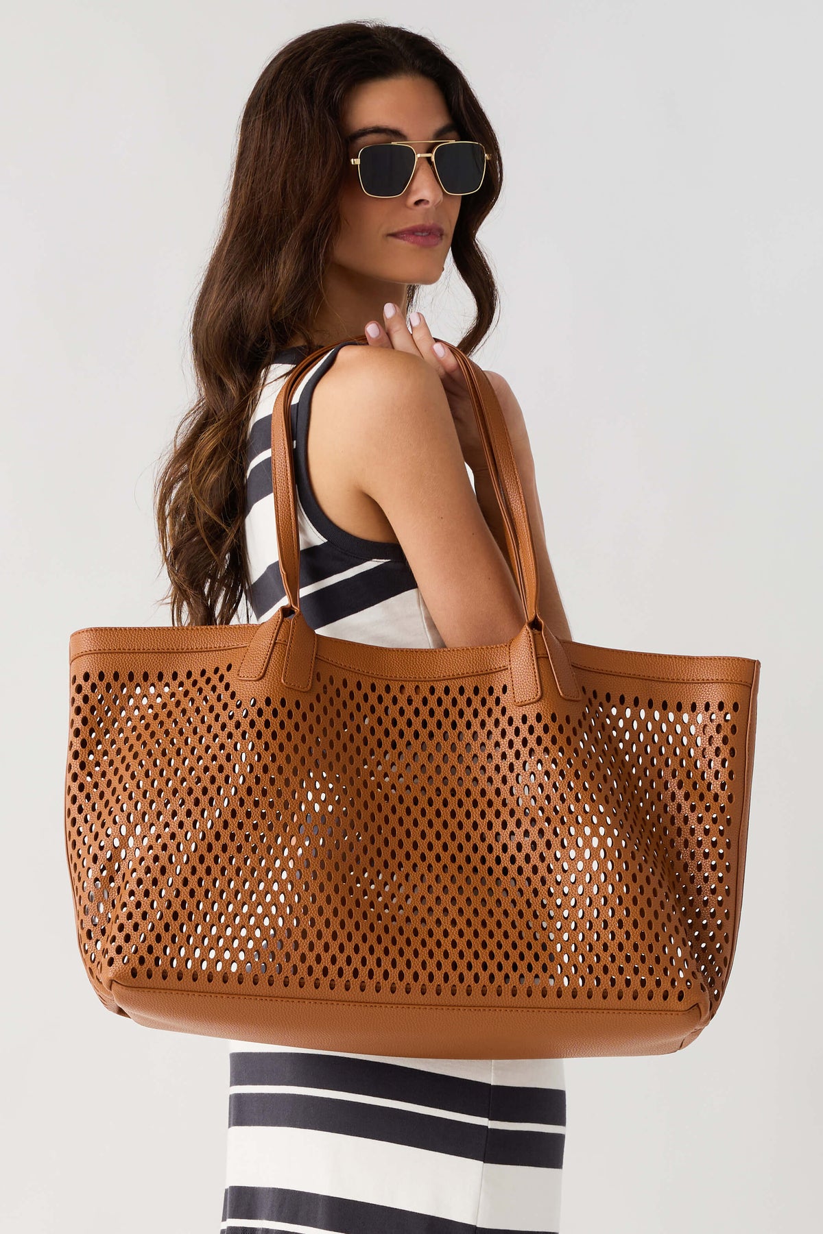 Tan perforated tote bag with wide handles and open top