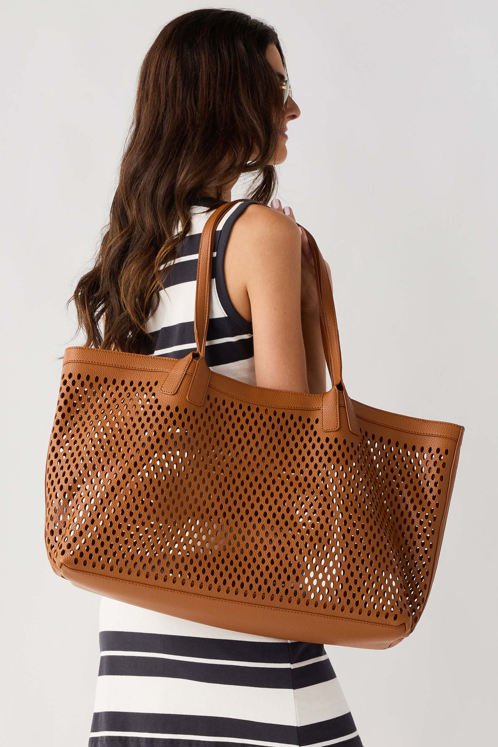 Tan perforated tote bag with wide handles and perforated side panels