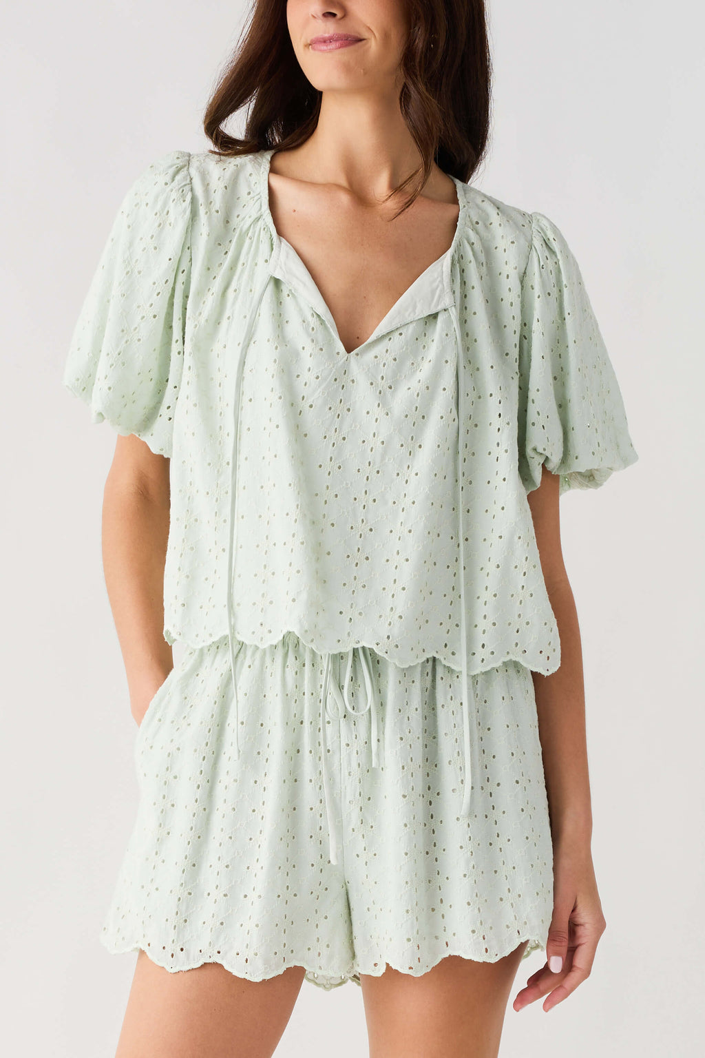 Mint eyelet lace top with V-neck and short flutter sleeves, tiered ruffle hem