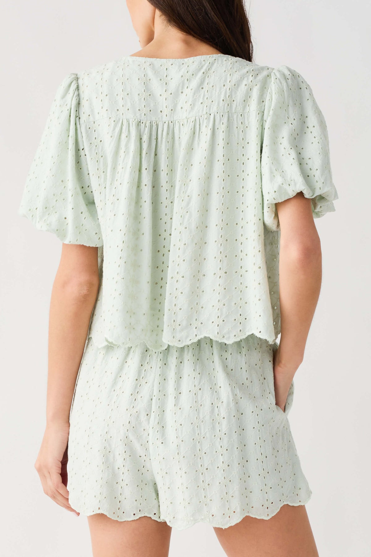 Mint eyelet lace top with back yoke and short puff sleeves, scalloped tiered hem