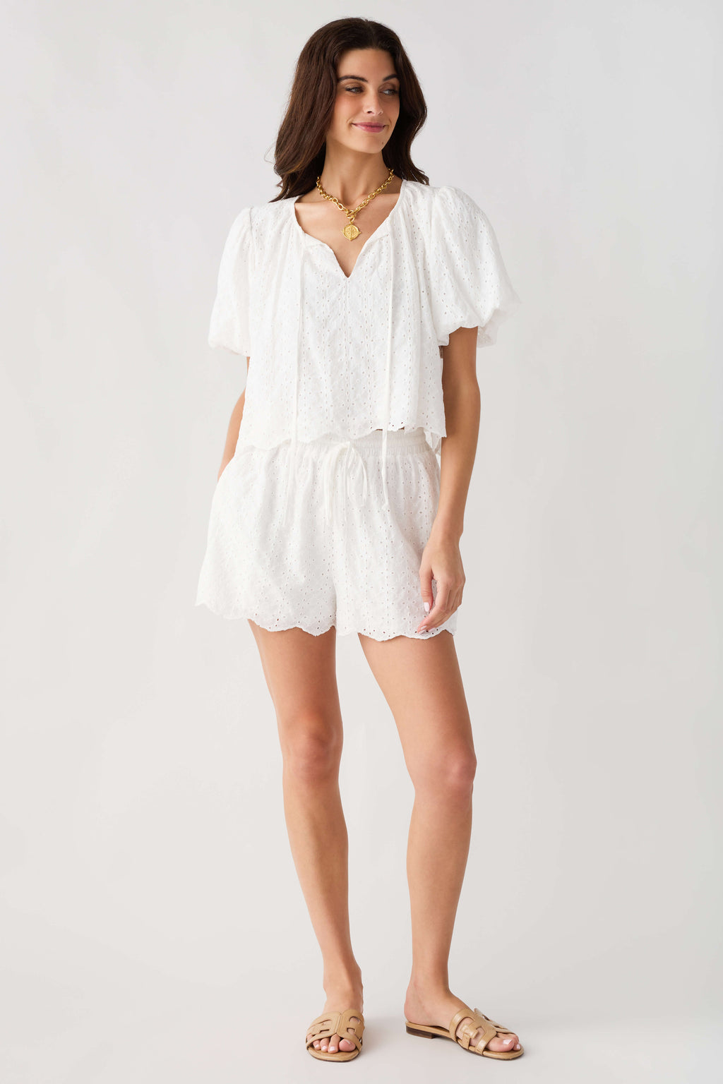 Off white eyelet lace top and shorts set with V-neck, puff sleeves, and scalloped edges