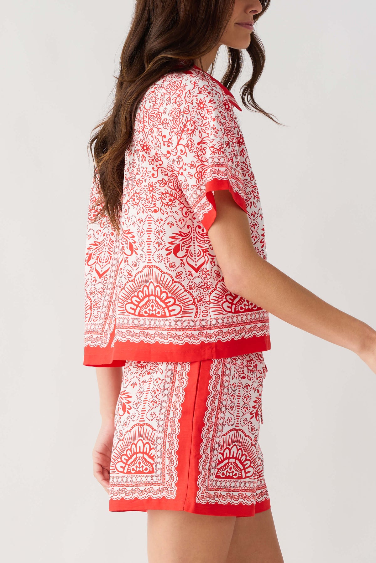 Red and white border-print short set back/side view: short-sleeve top with yoke panel