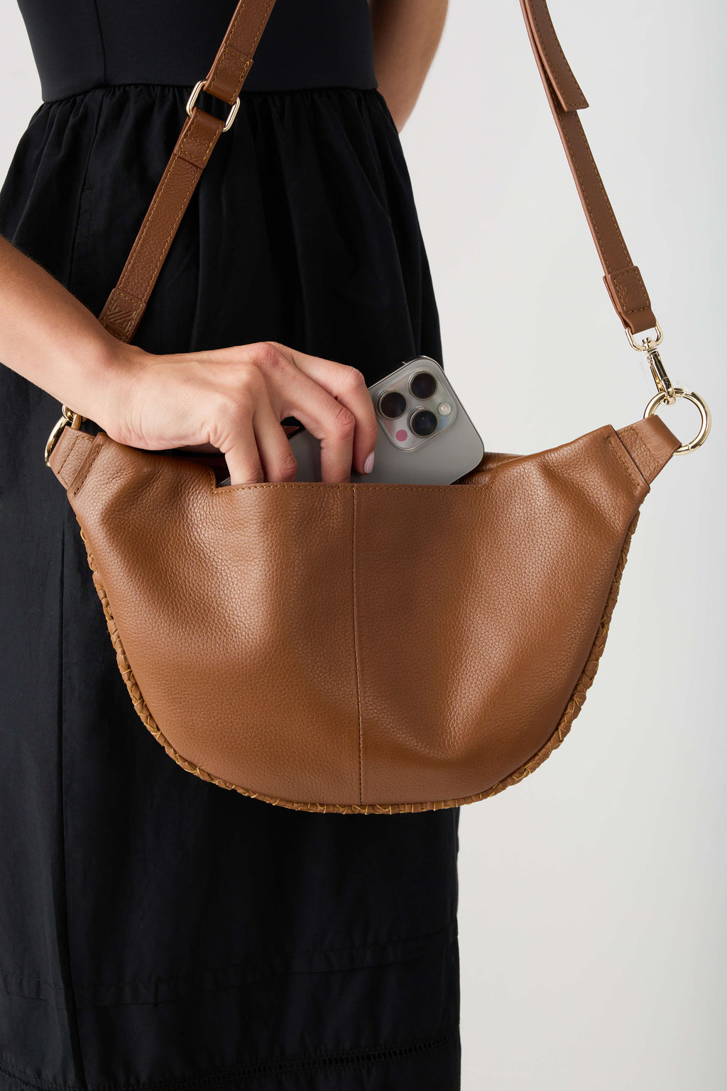 Camel leather-trimmed sling bag with open top, front seam, adjustable crossbody strap
