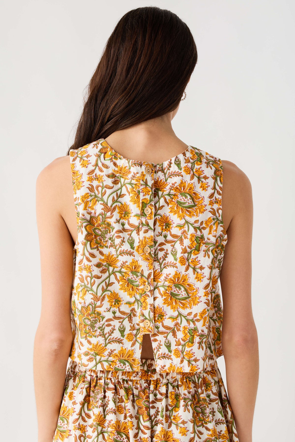 Floral print sleeveless top with back view and gathered peplum hem