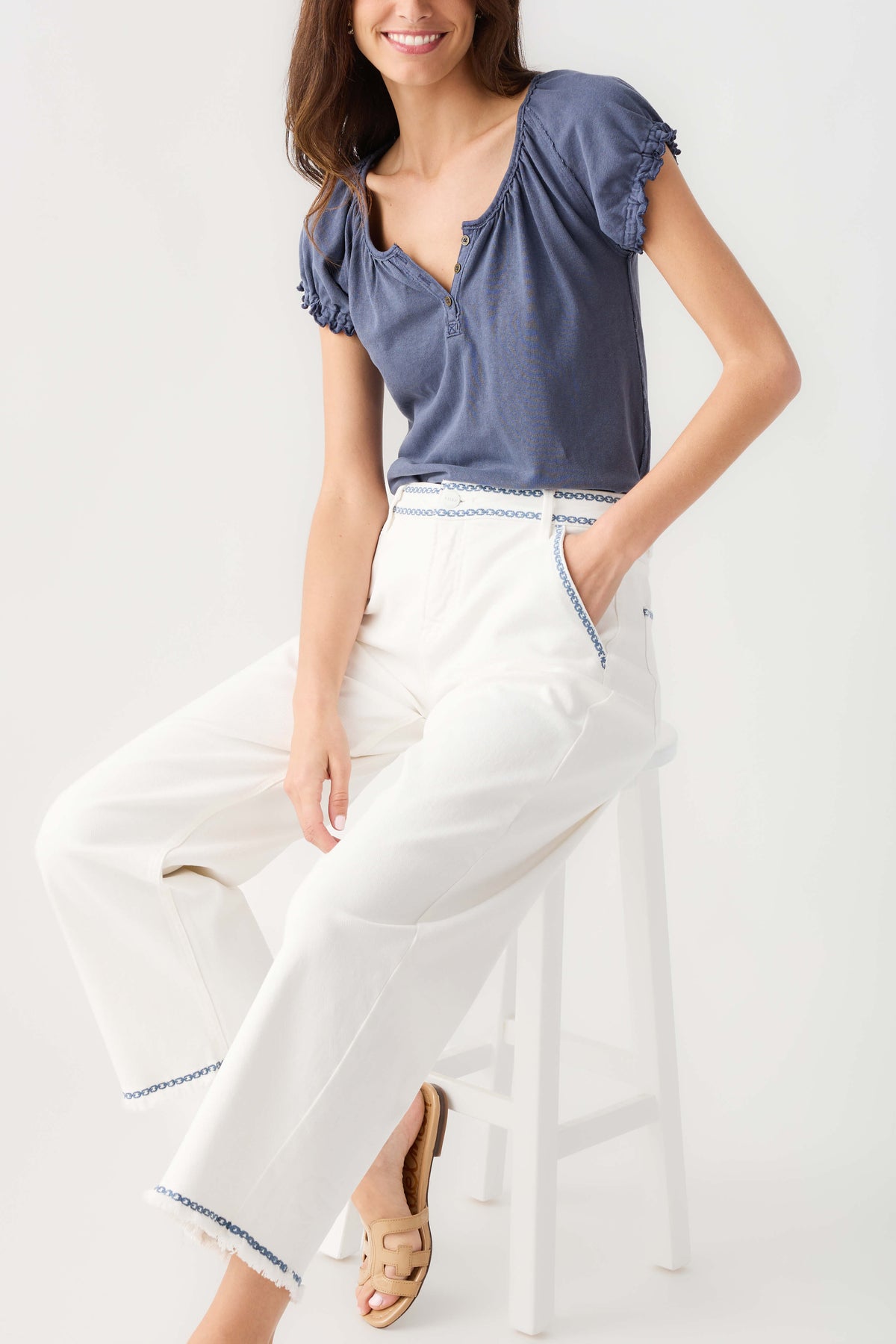 Cream embroidered cropped barrel jeans with blue trim, front and side seams visible