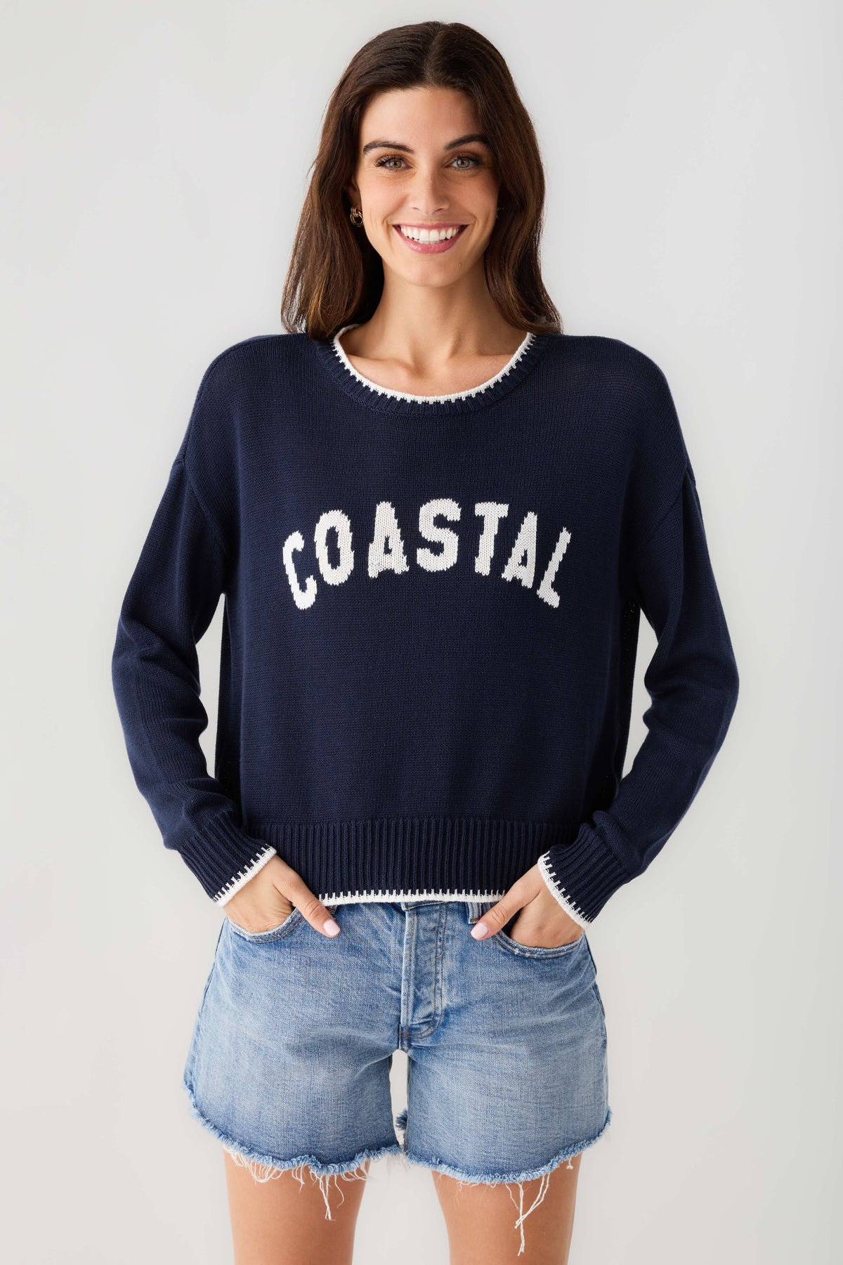 Navy knit crewneck sweater with white-trim collar and 'COASTAL' front graphic
