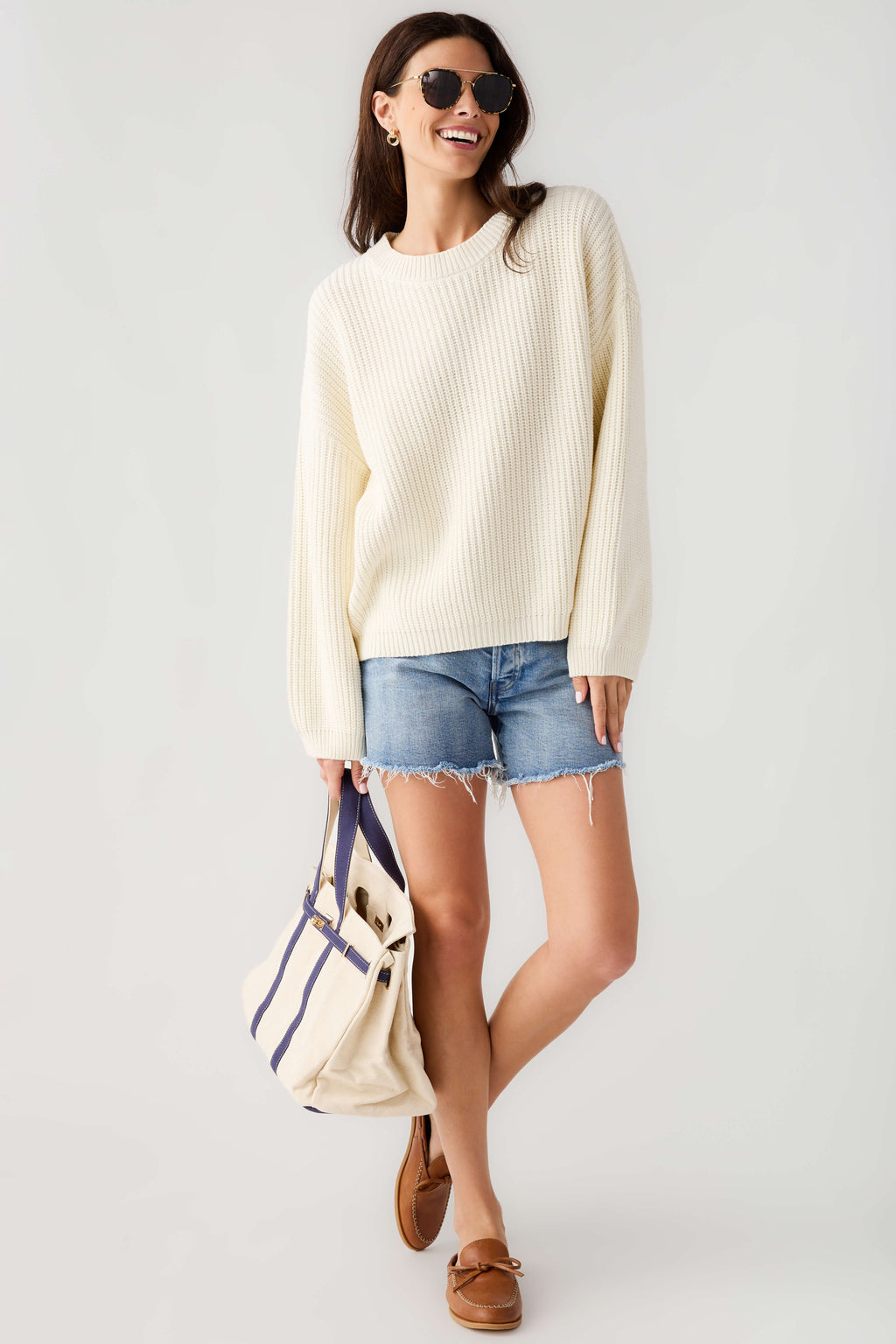 Cream knit pullover top with crew neck, long sleeves, and straight hem