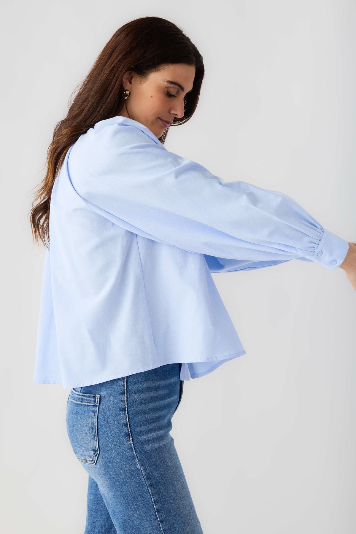 Light blue ruffle button-down blouse with wide balloon sleeves and button front