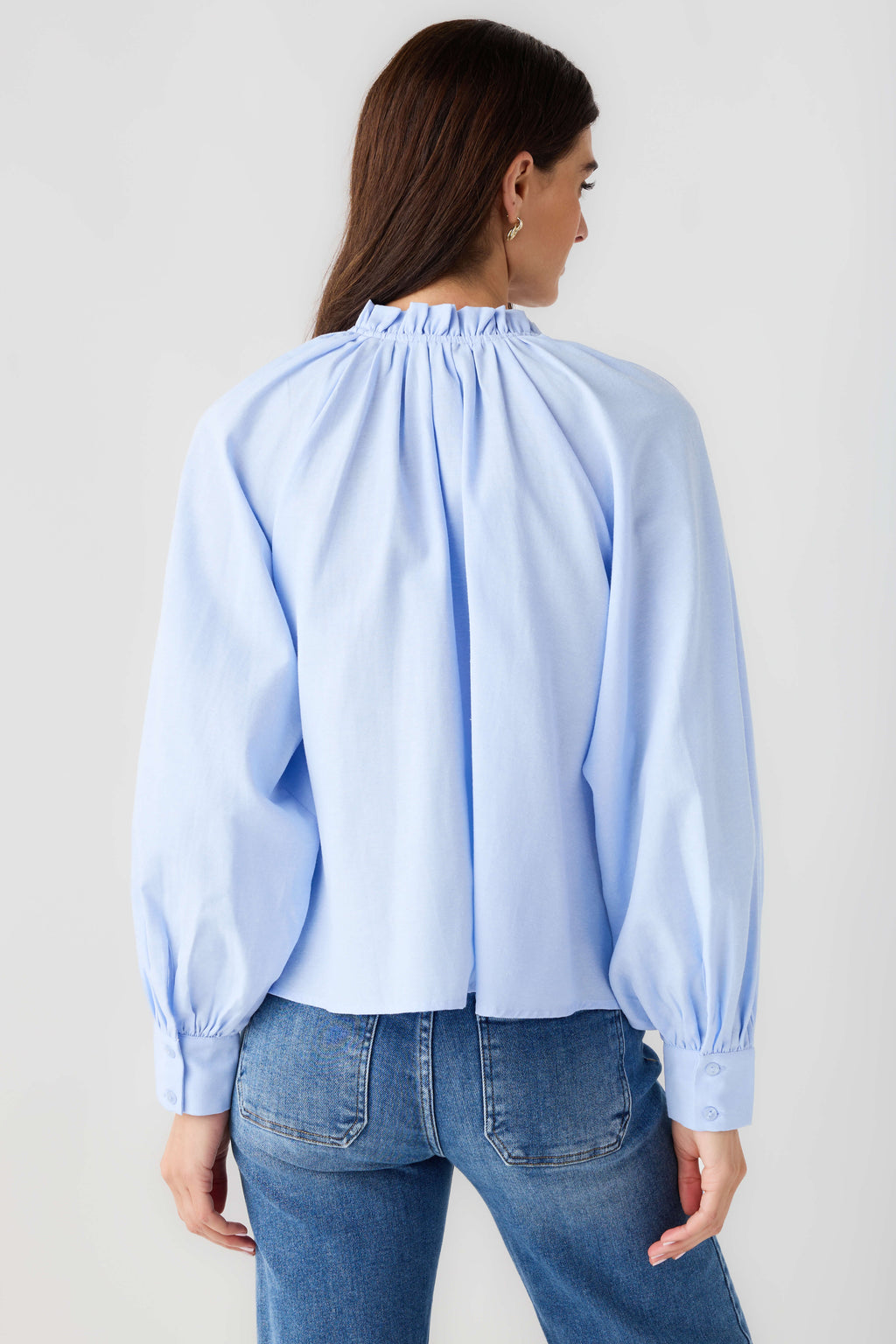 Light blue ruffle button-down top with back yoke pleats and gathered cuffs