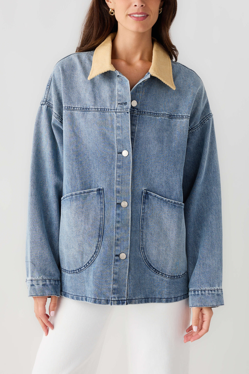Light blue denim jacket front with tan corduroy collar, chest pockets and button placket